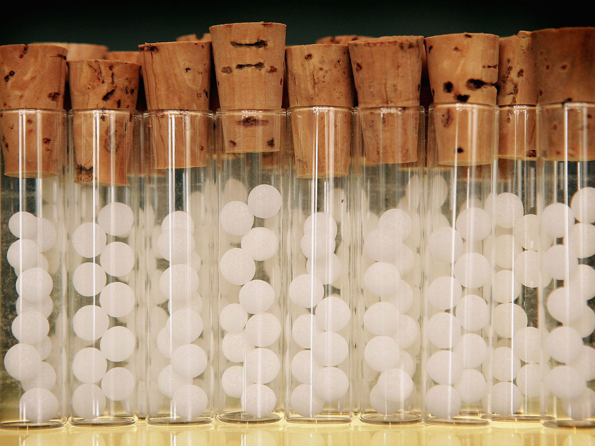 Vials containg pills for homeopathic remedies are displayed at Ainsworths Pharmacy on August 26, 2005 in London.