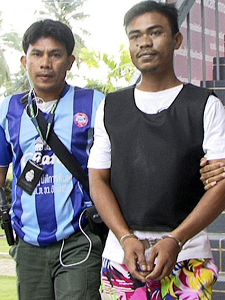 The alleged Thai gunman Ekkapan Kaewkla, right, is arrested