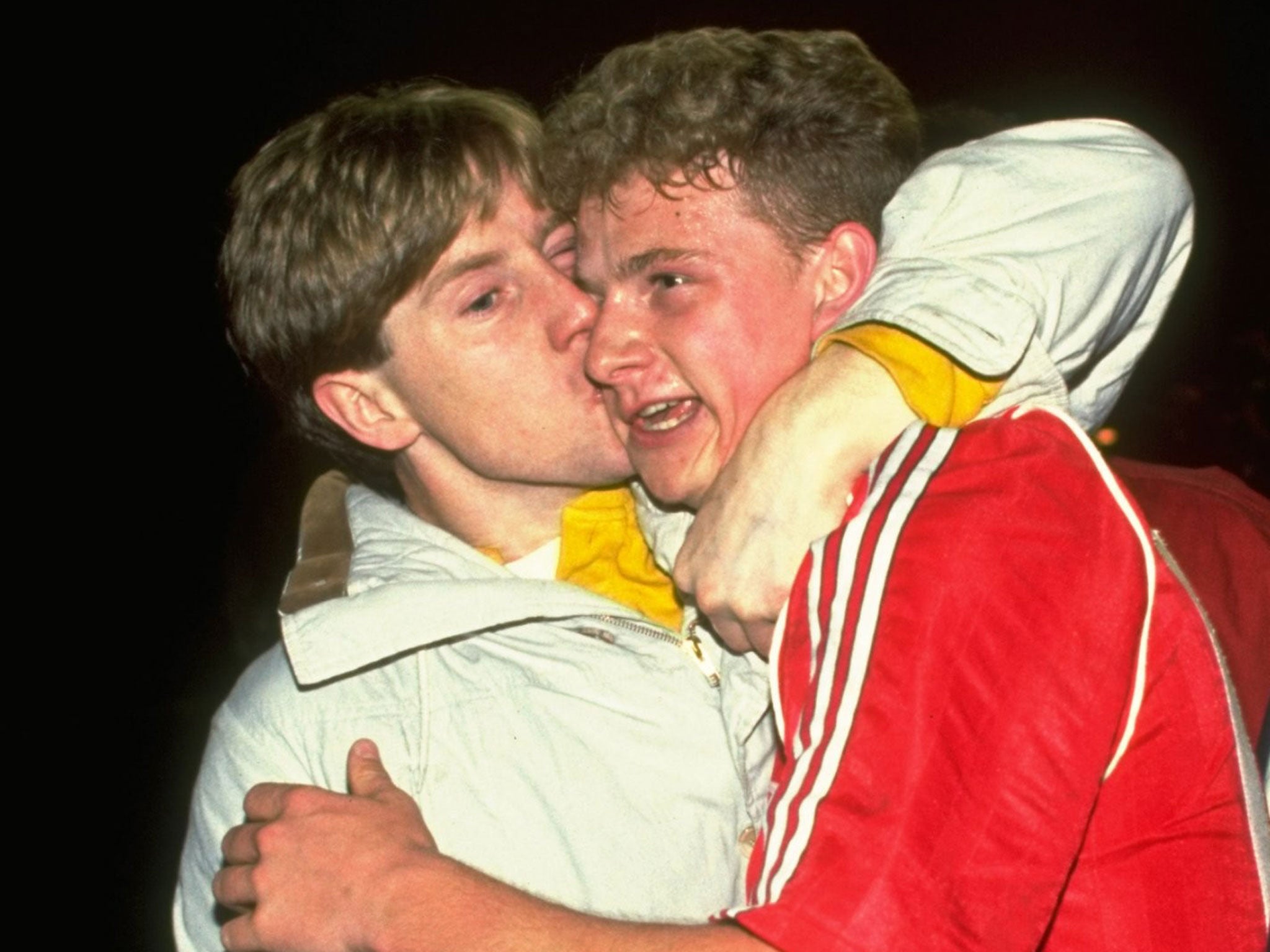 Mark Robins gets a hug from a fan in his United playing days