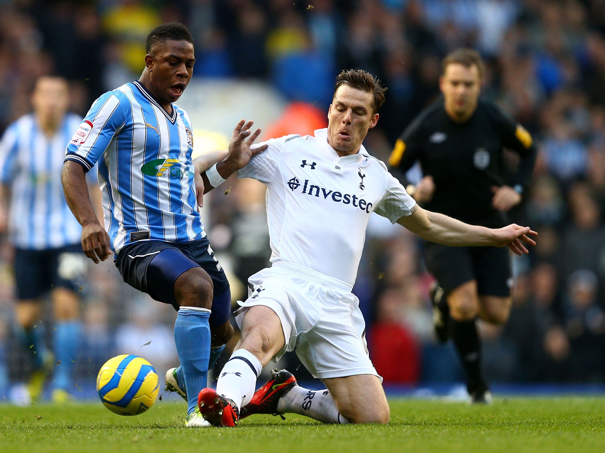 Franck Moussa of Coventry City is challenged by Scott Parker of Tottenham Hotspur