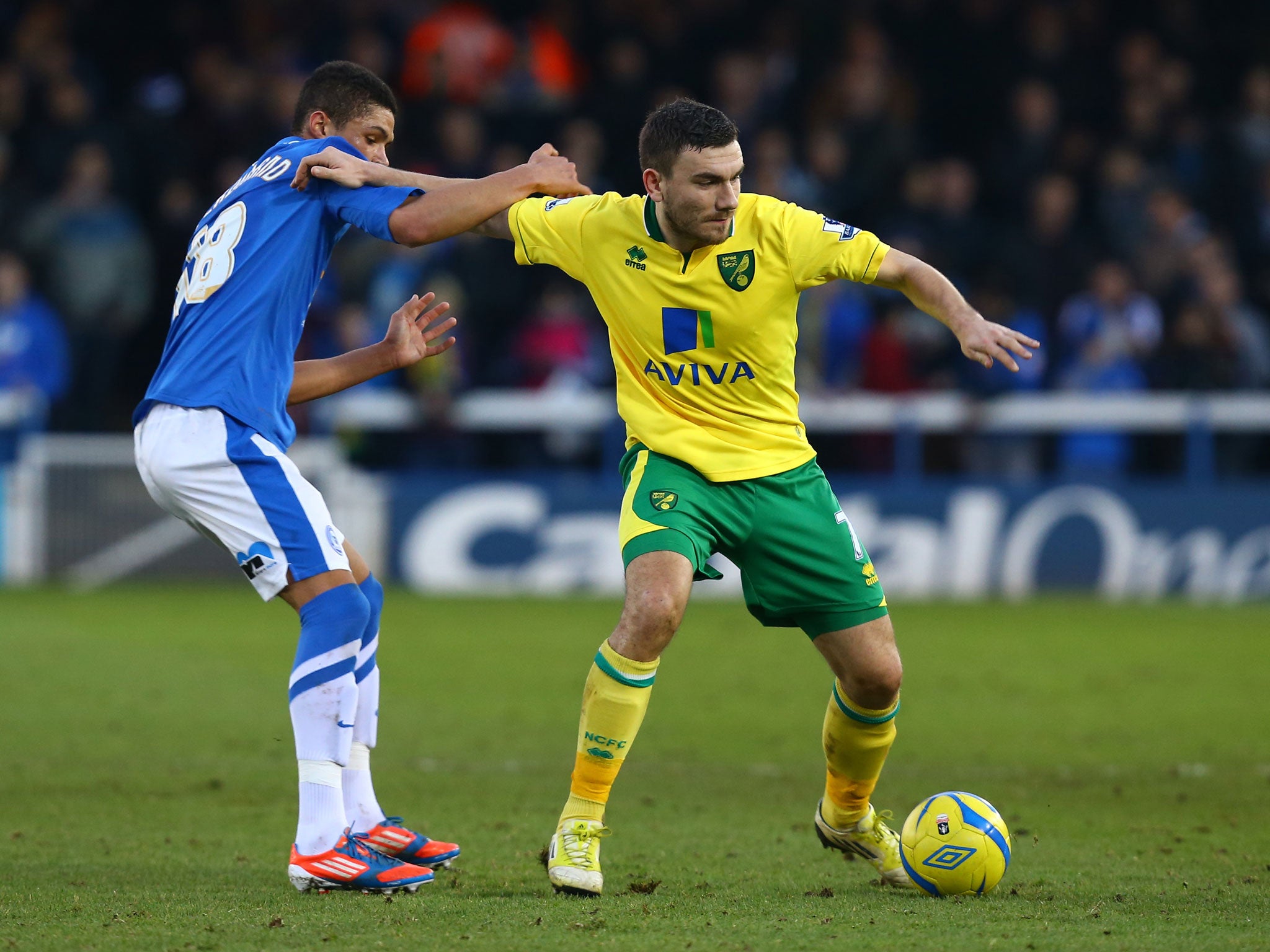 Robert Snodgrass of Norwich City is put under pressure by Kane Ferdinand