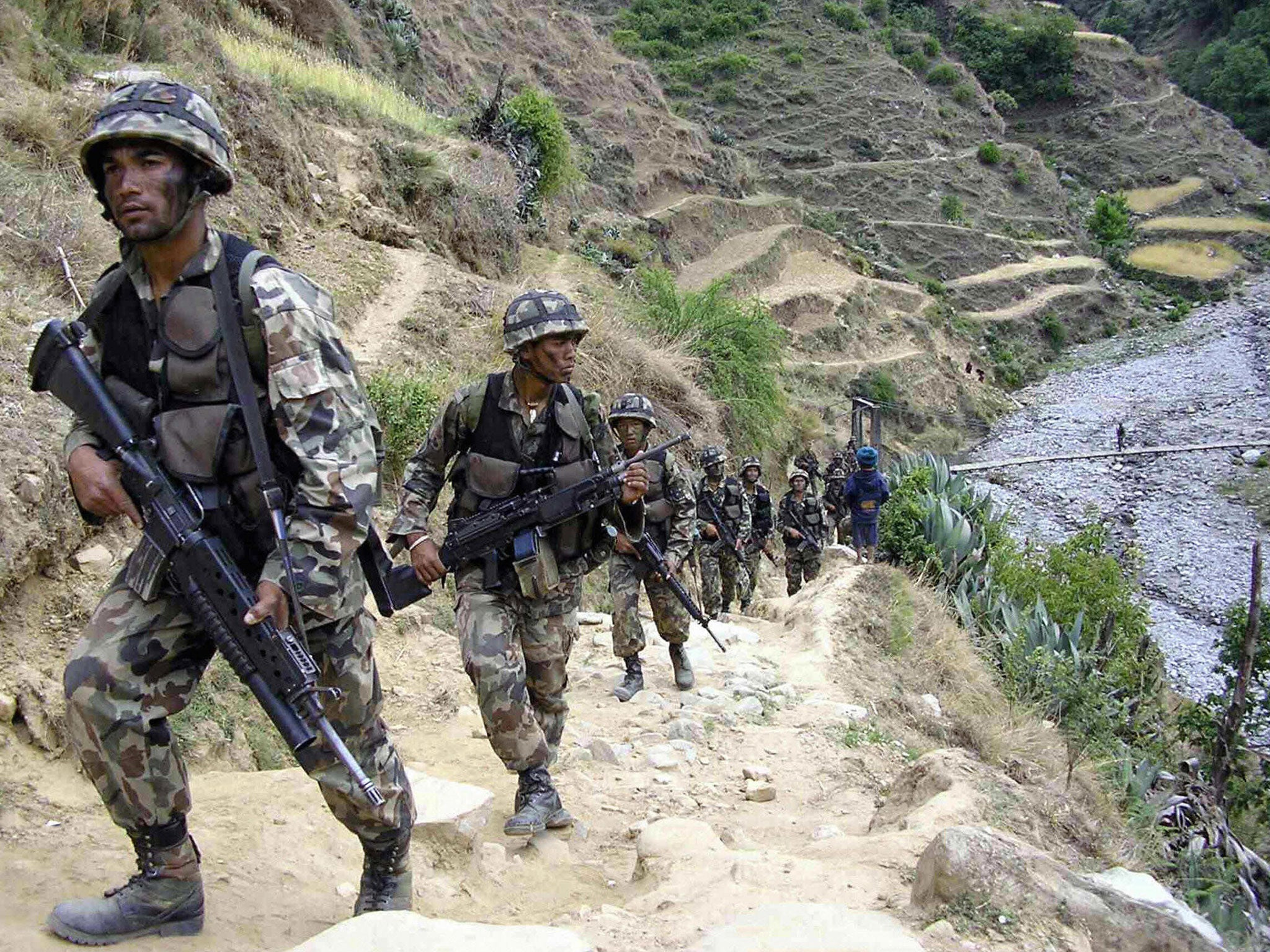 Nepalese soldiers patrol in Rolpa, about 350km west of Kathmandu, a year before the end of the Maoist conflict in 2006