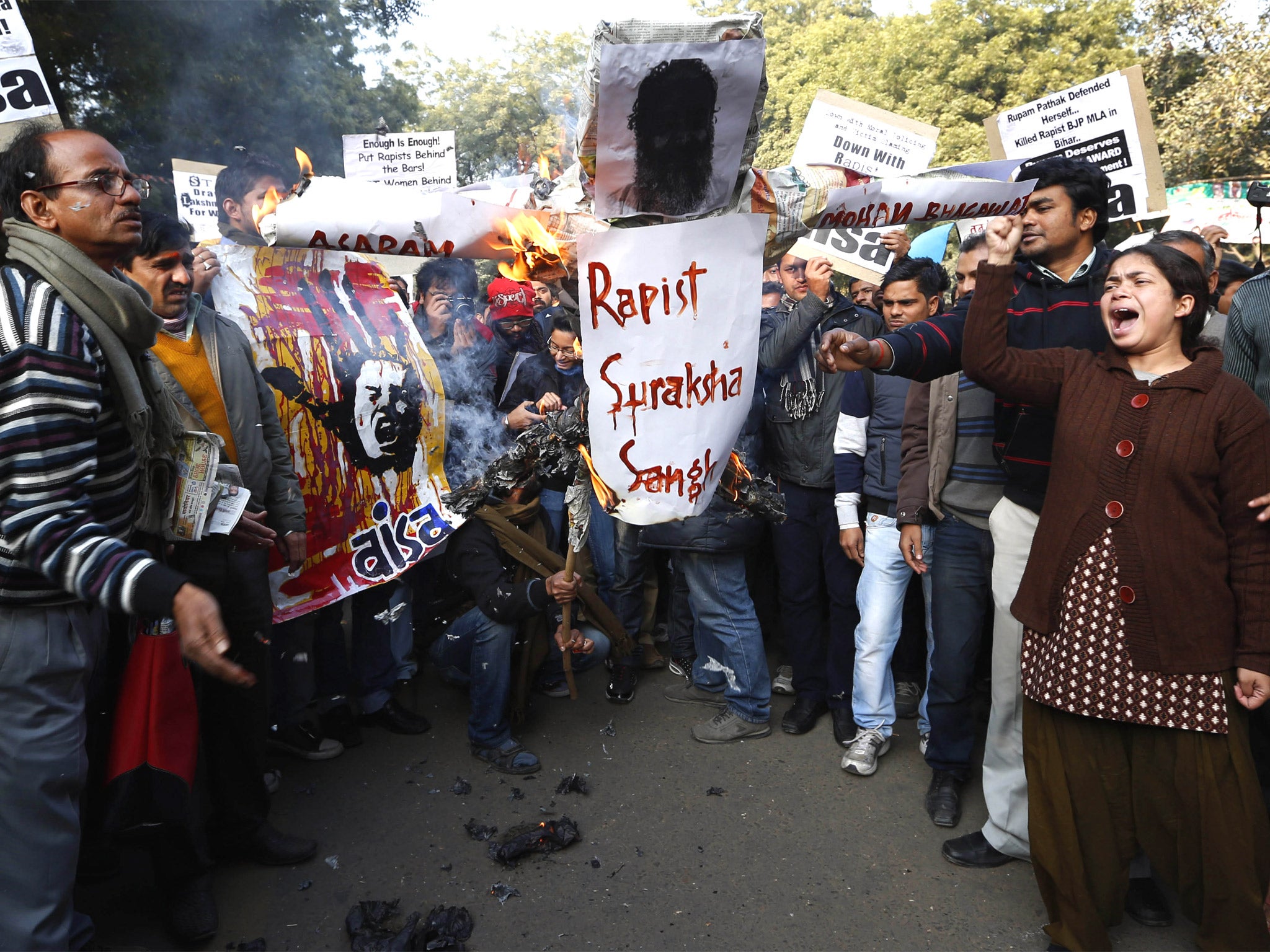 Indian students burn an effigy representing Hindu religious leader Asaram Bapu and Mohan Bhagwat, leader of National Volunteers Association