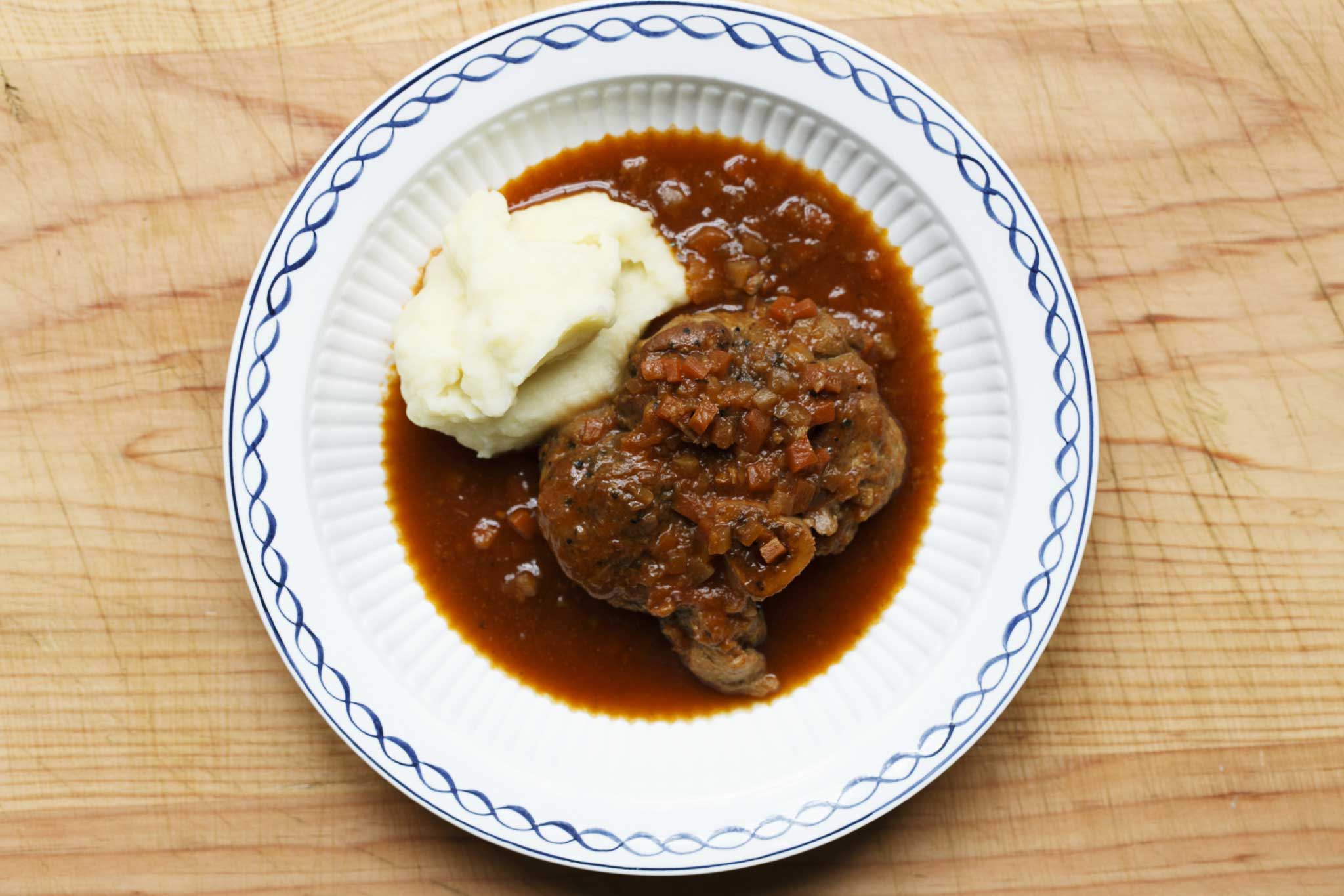 Serve braised shin of pork with cheesy mashed potato or creamy polenta