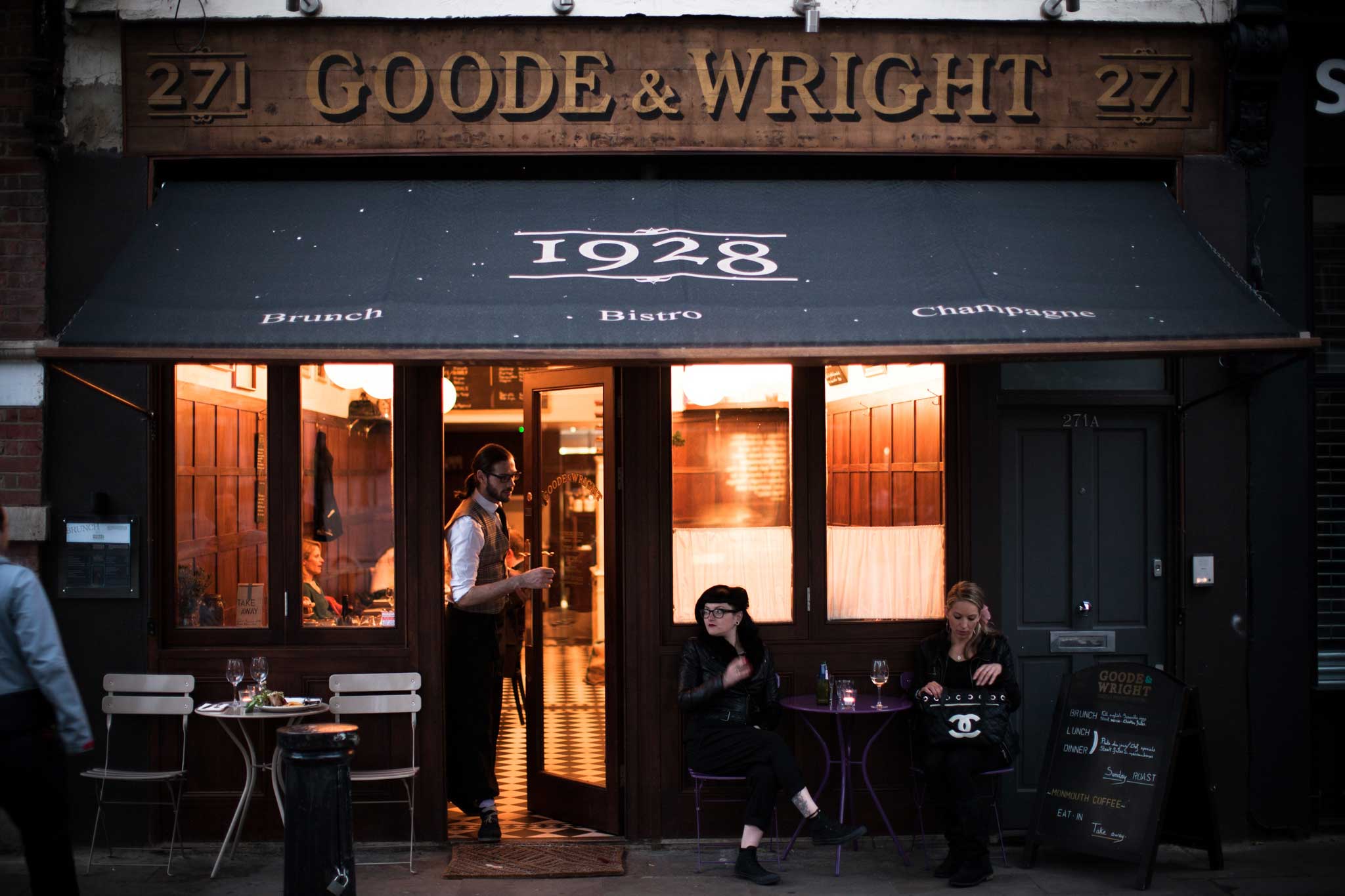 Goode & Wright is starkly designed with wood-panelled walls, dangling globe lights and half-curtained windows