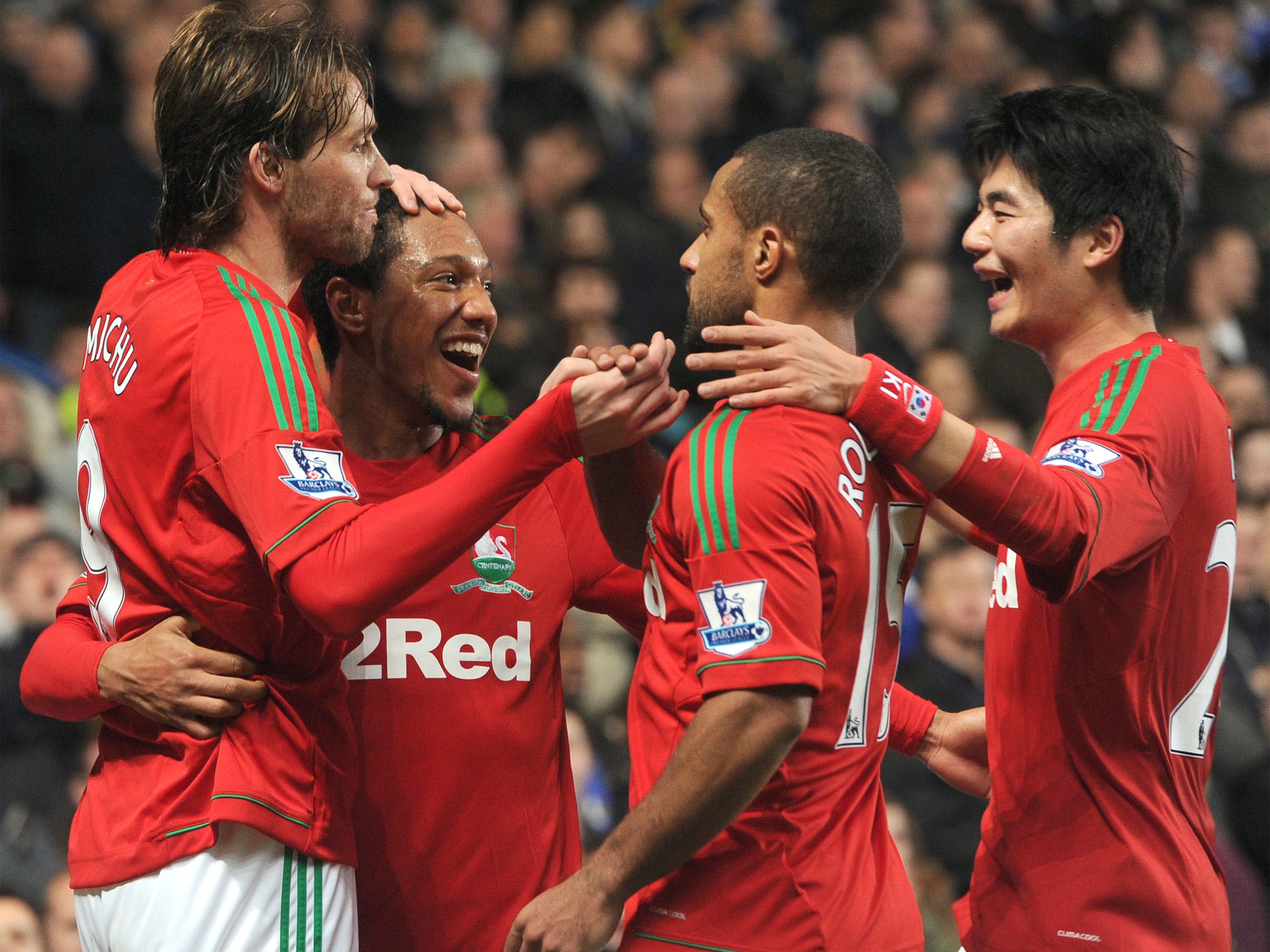 The Swansea players celebrate Michu’s opener