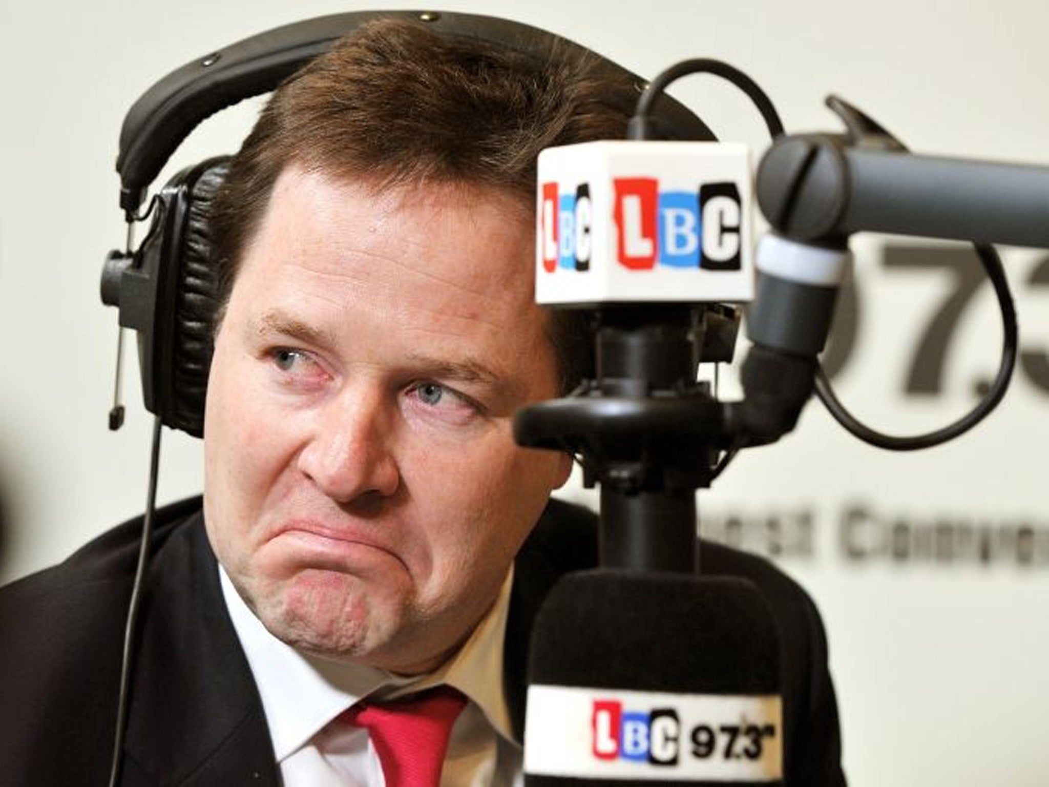 The Deputy Prime Minister Nick Clegg listens to a question from a listener during the LBC radio phone-in programme with host Nick Ferrari