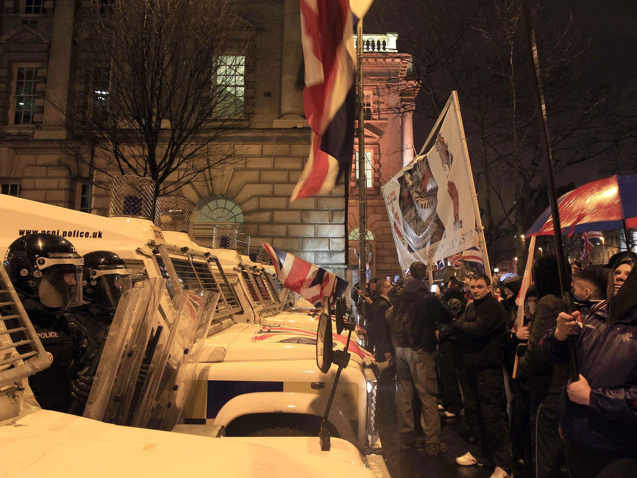 Loyalist protesters confront riot police at Belfast City Hall
