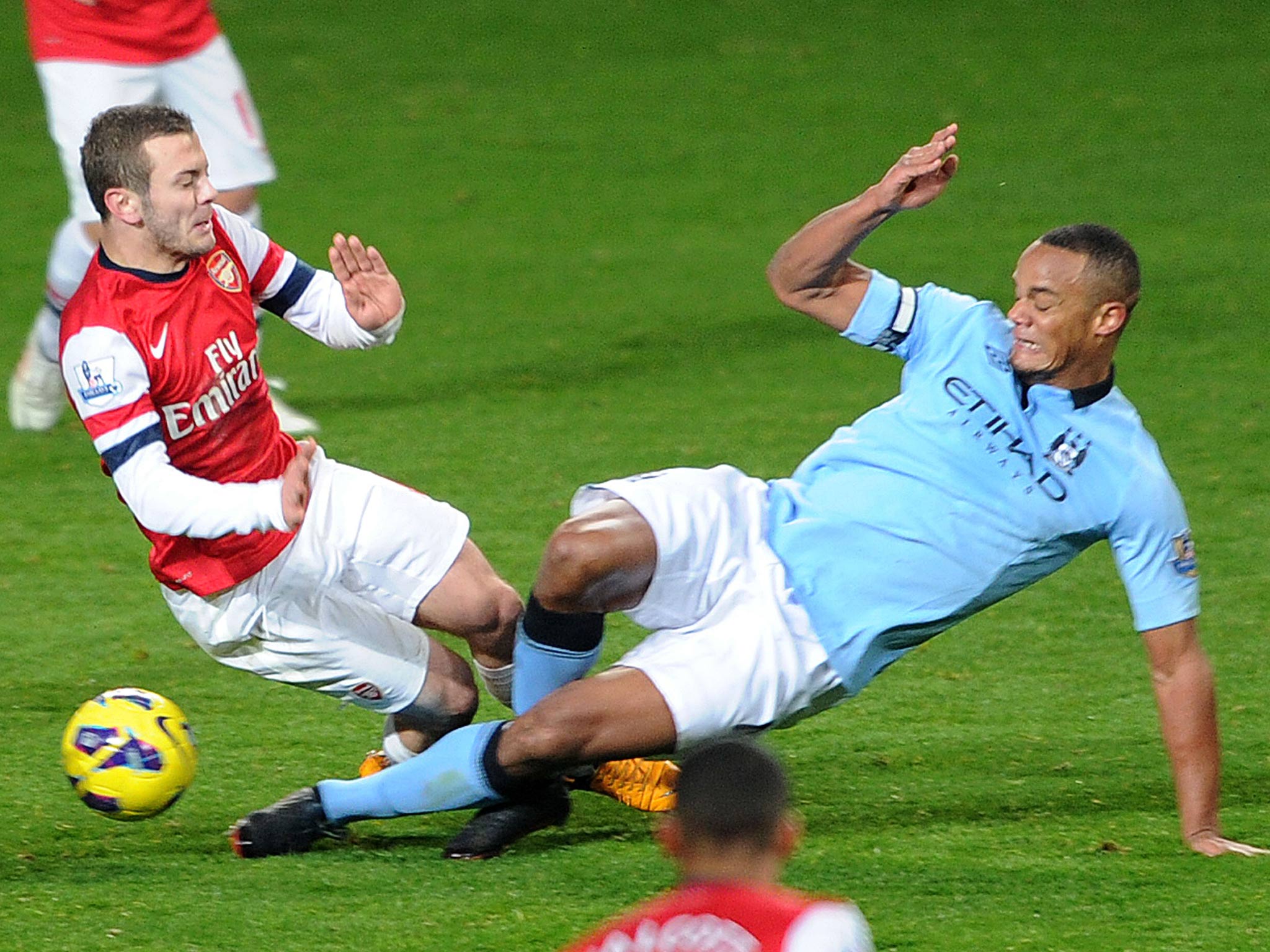 Vincent Kompany makes a challenge on Jack Wilshere which leads to a sending off