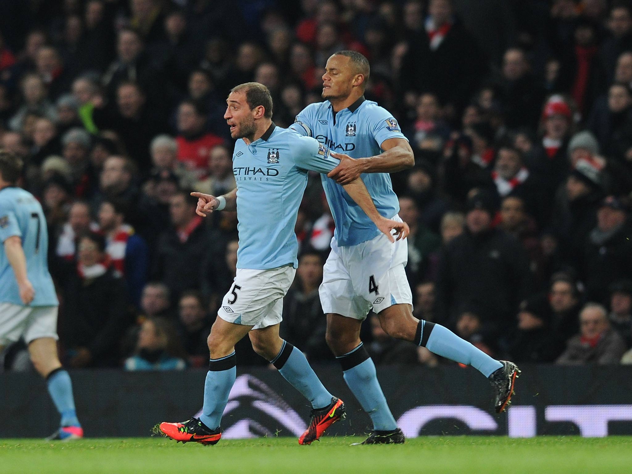 Pablo Zabaleta is held back by Manchester City captain Vincent Kompany