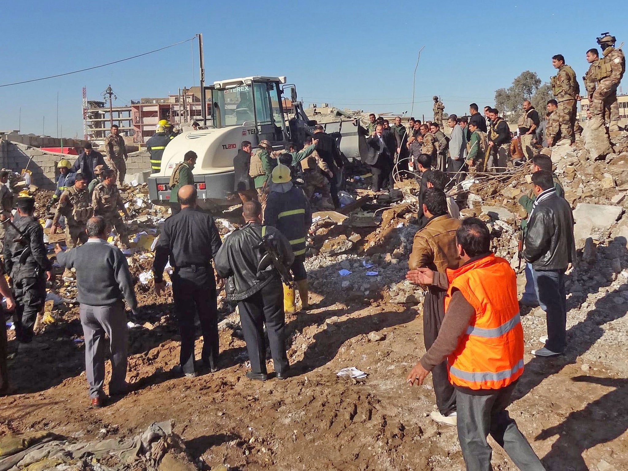 Iraqi rescuers work at the site of a suicide bomb attack in Kirkuk city, northern Iraq