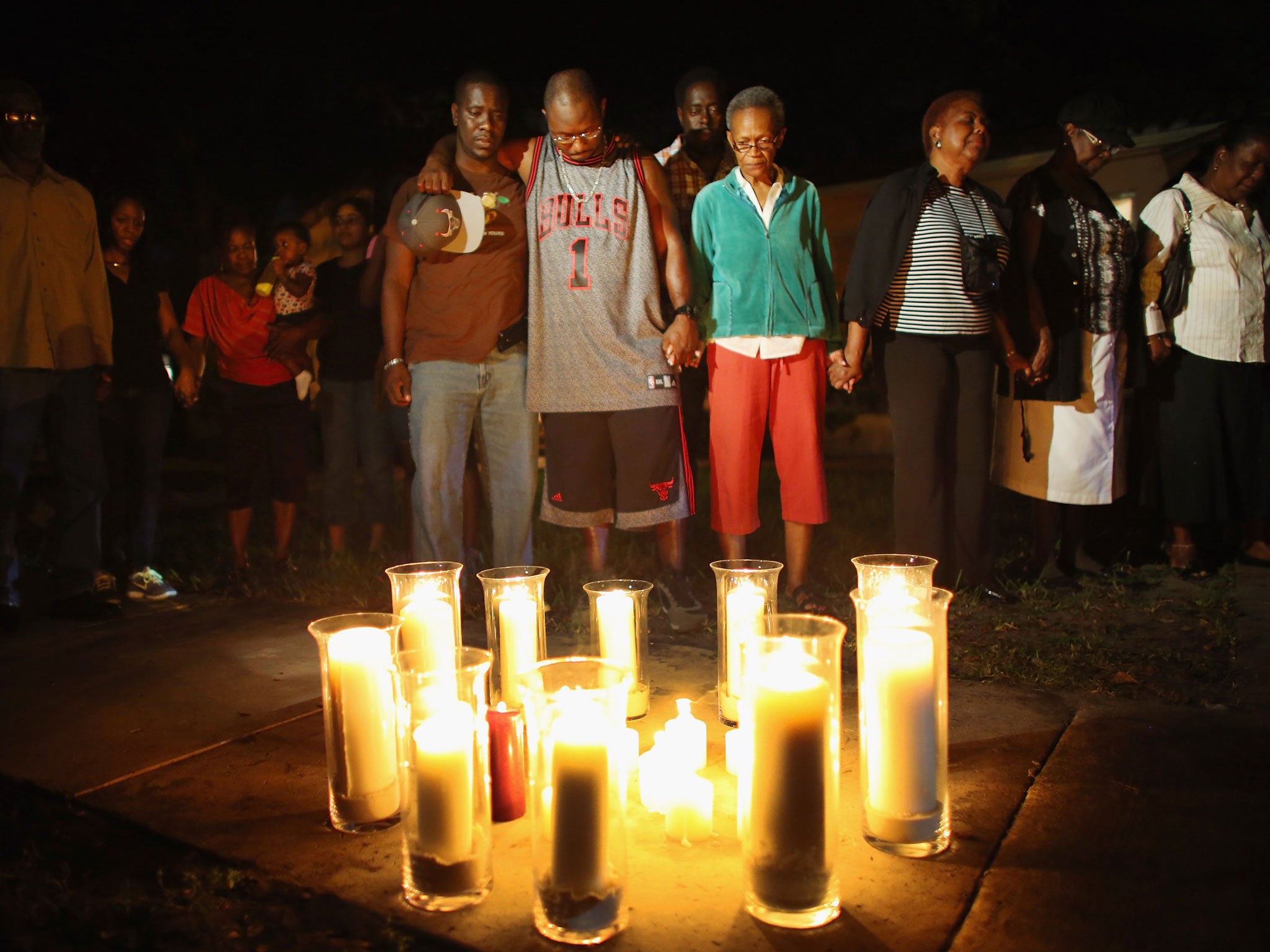 The family and friends of Kori Clark attend a candle light vigil after he was shot. Kori is one of nearly a thousand people who have been killed by guns since Sandy Hook