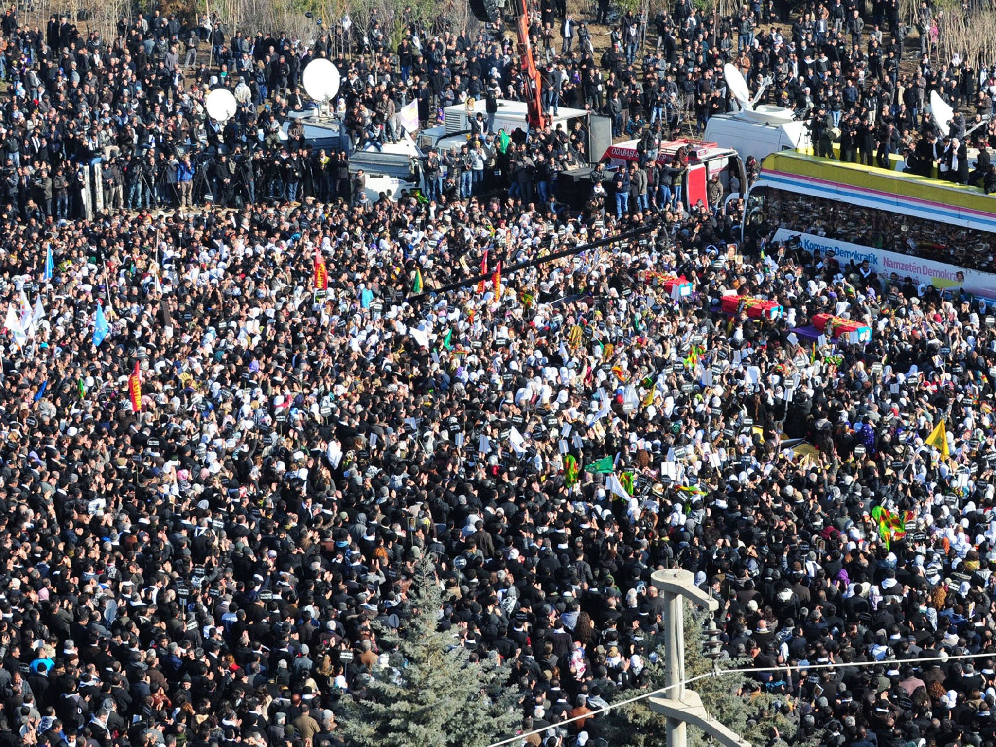 Thousands of Kurds carry the coffins of the three top Kurdish activists Sakine Cansiz, Fidan Dogan and Leyla Soylemez - shot dead in Paris - in Diyarbakir