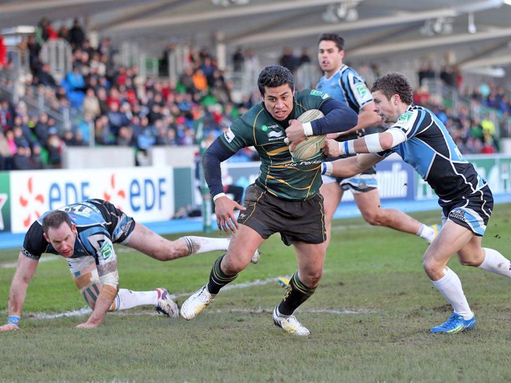 Northampton’s George Pisi fights his way through to score a try