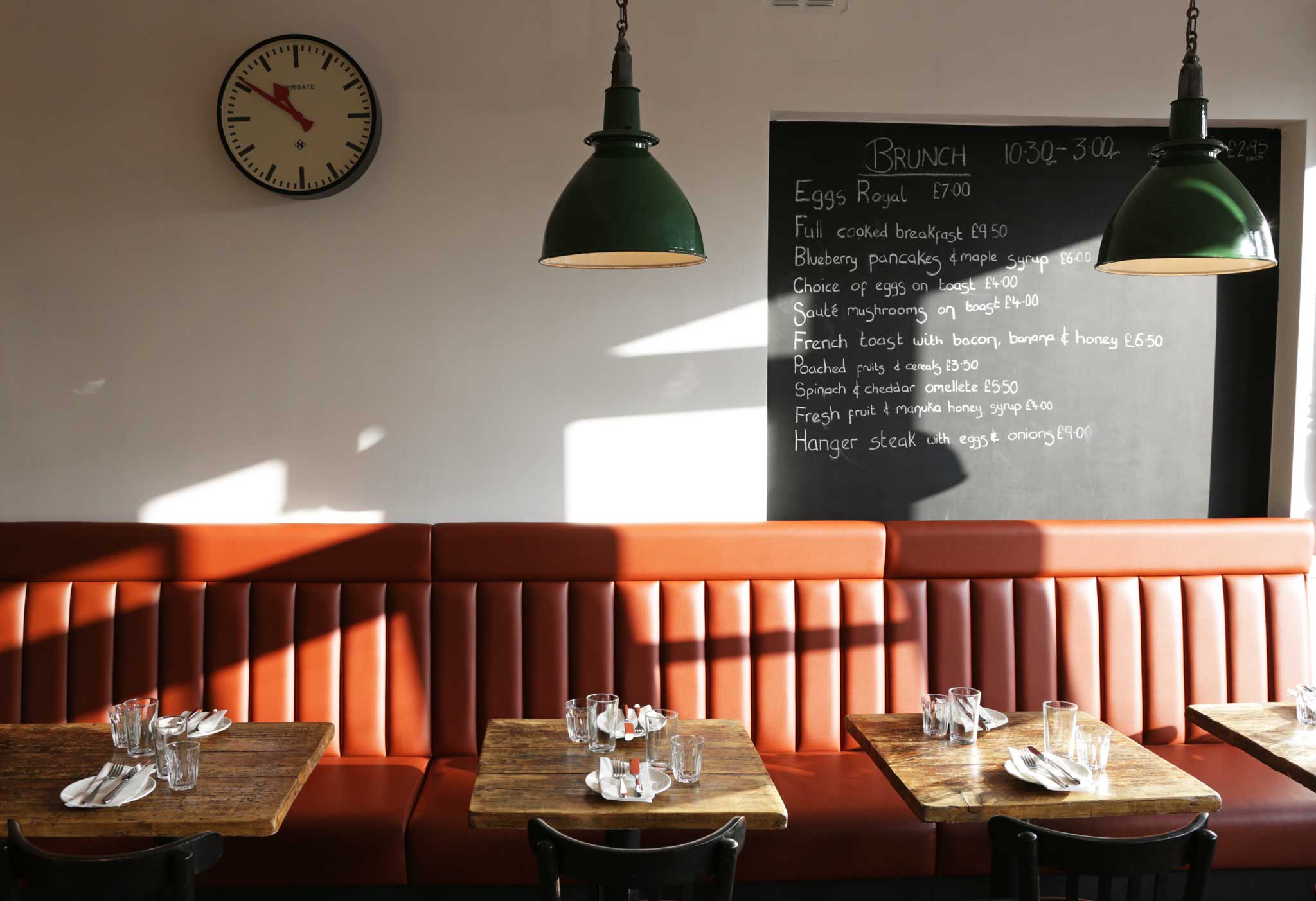 Manuka Kitchen's décor is minimal: tiny wood tables, terracotta tiles, plain white walls with dangling green lamps