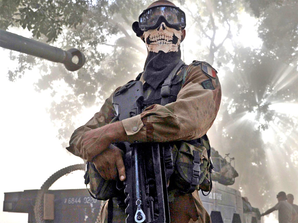 A French soldier wearing a skeleton mask in a street in Niono on Sunday