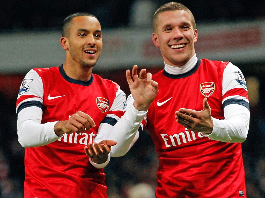 Theo Walcott celebrates scoring his goal with star performer Lukas Podolski