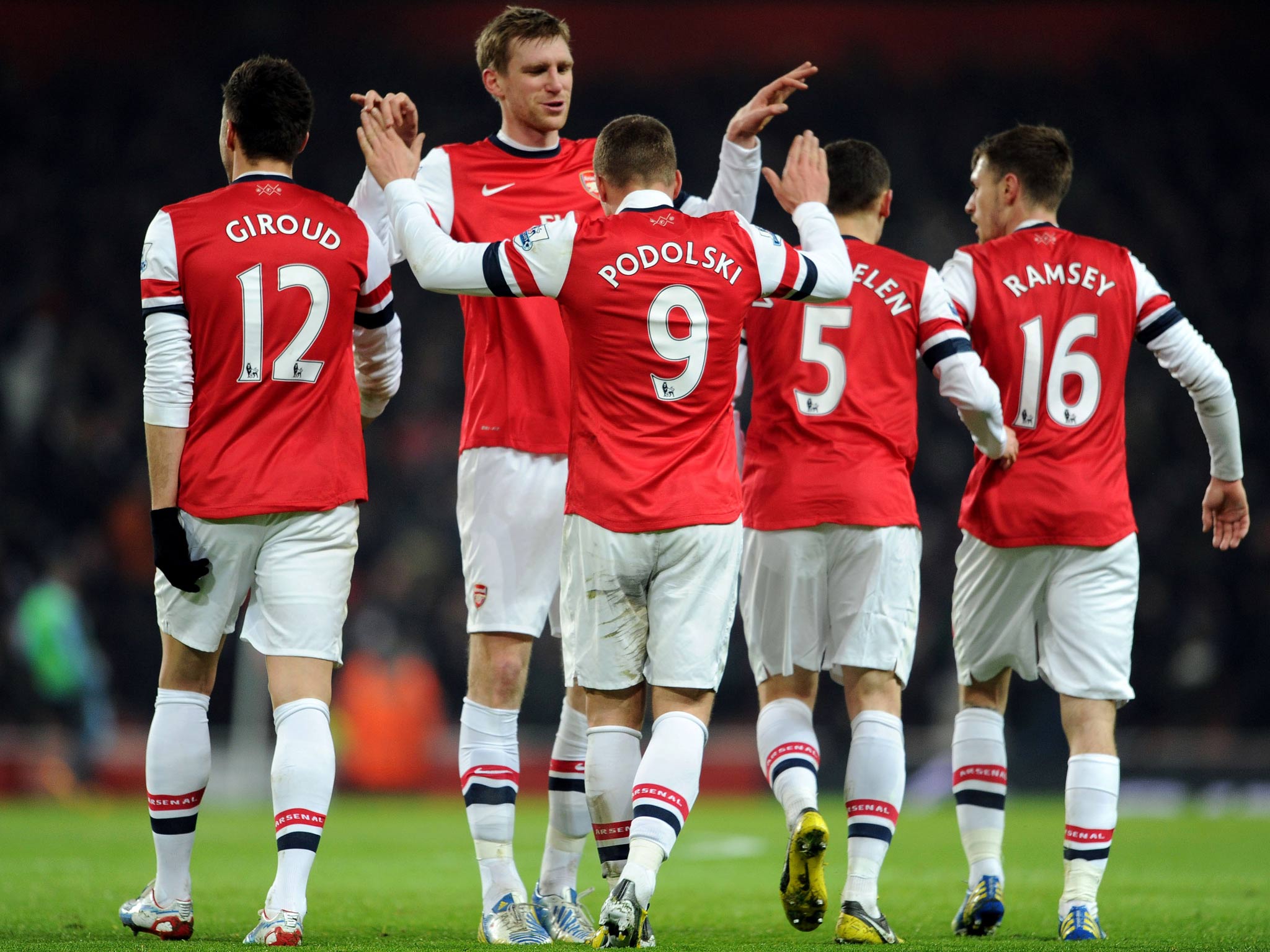 Lukas Podolski celebrates scoring Arsenal's first goal against West Ham