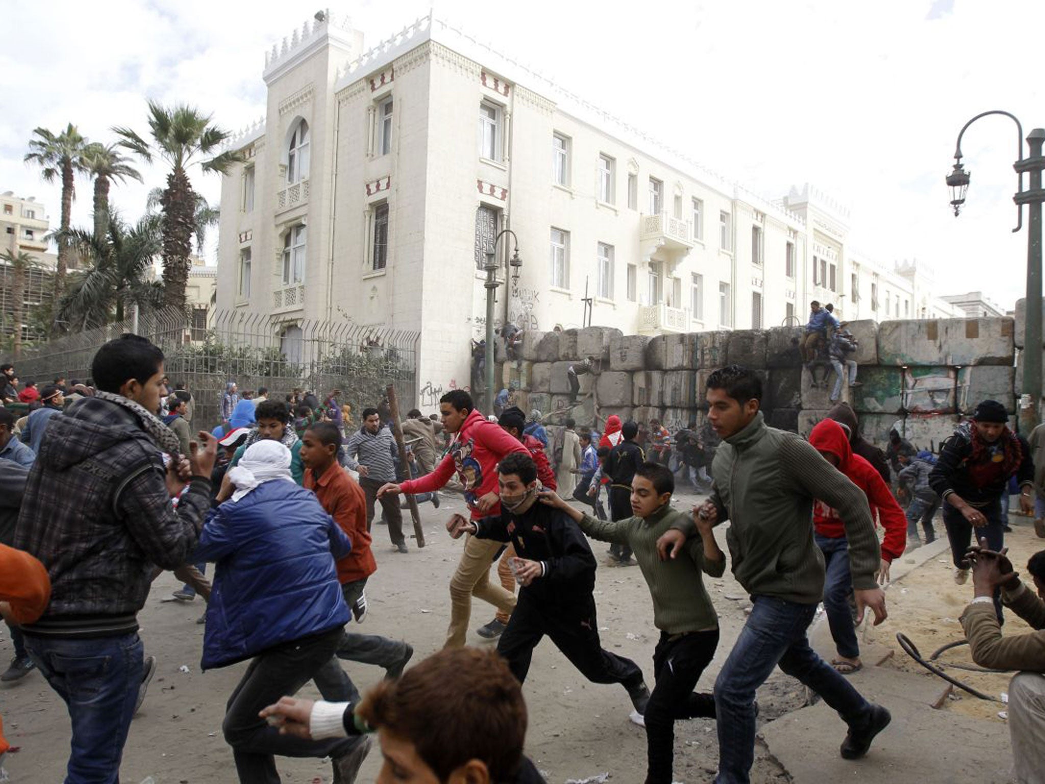 Protesters scatter during clashes with police near Tahrir Square