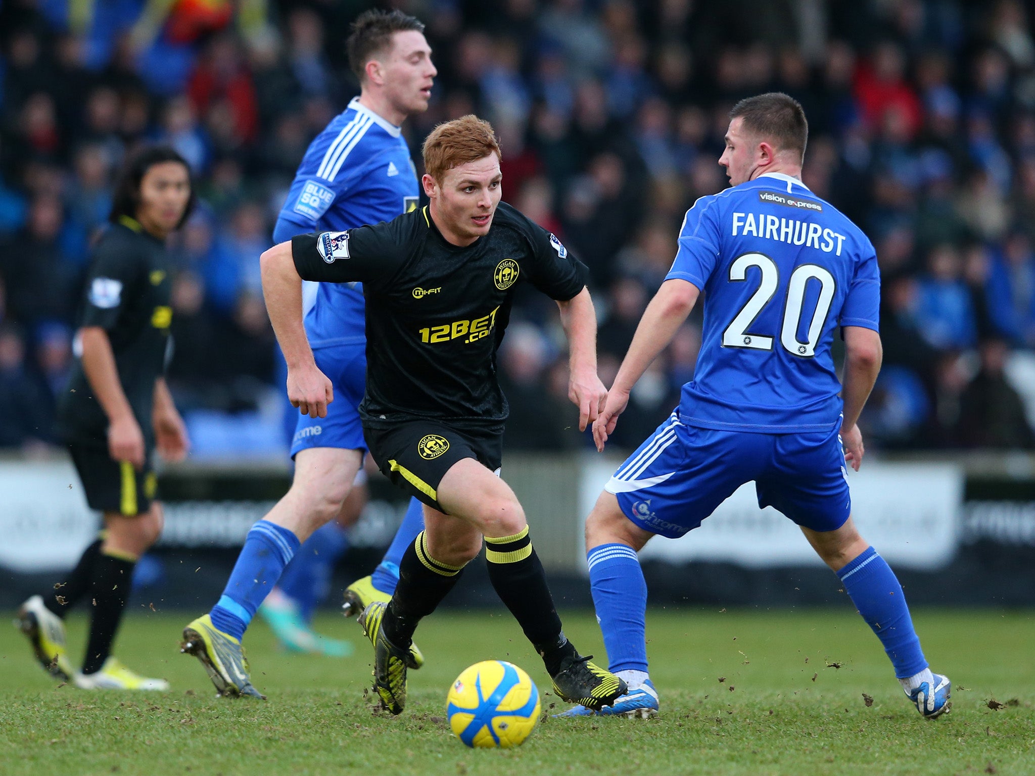 Fraser Fyvie of Wigan Athletic breaks away from Waide Fairhurst of Macclesfield Town