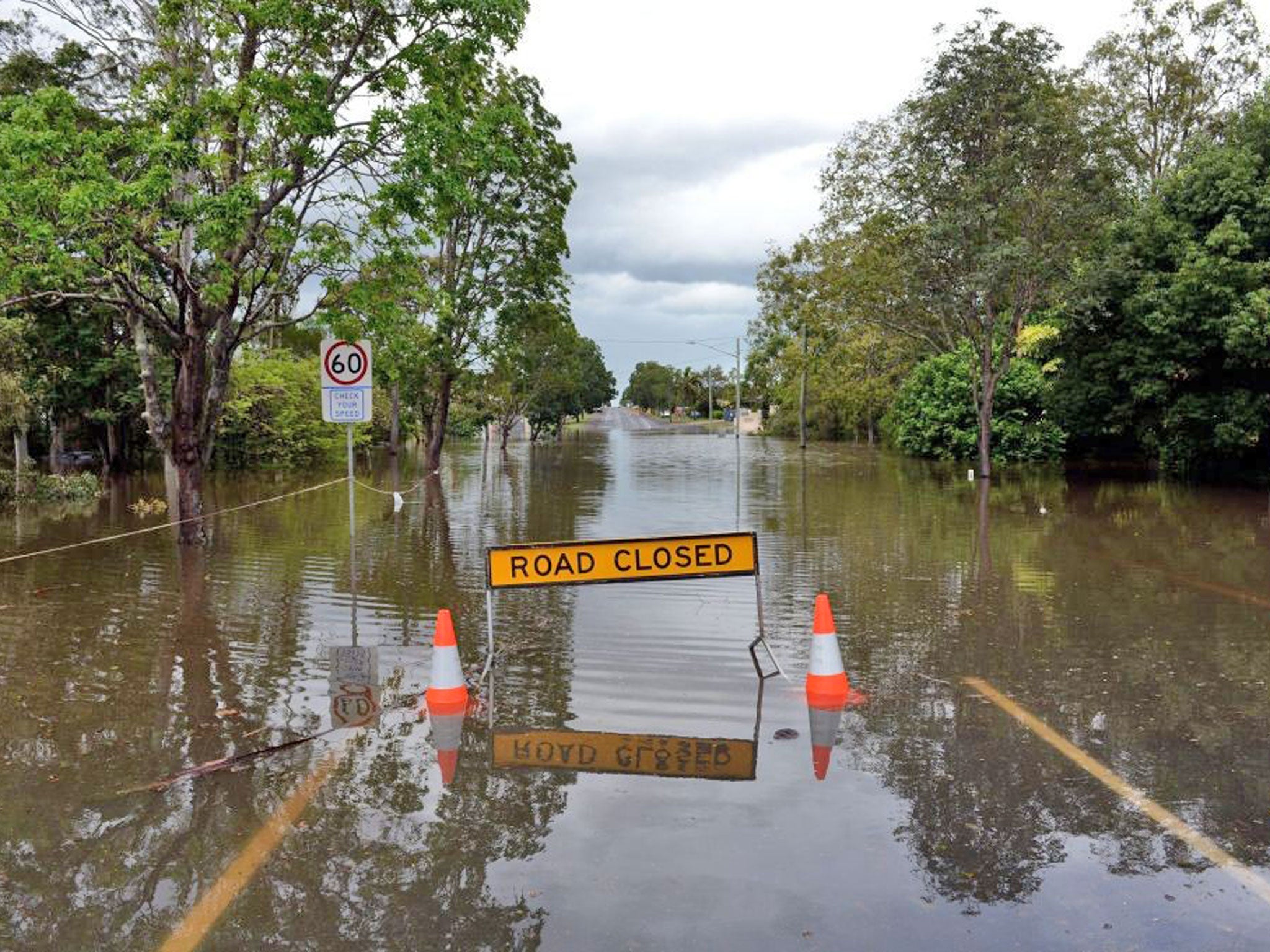 Flooded road is impassible in Bundaberg, Queensland. At least 1200 properties are already flooded, and there are fears that could reach 2000