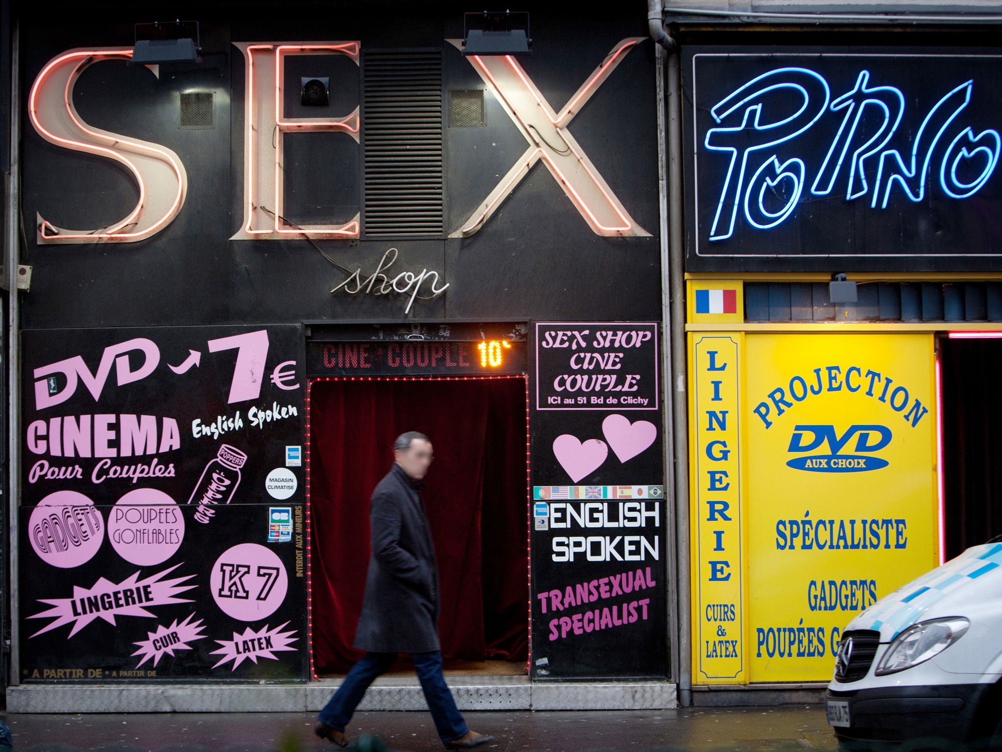 A man walks in front of a sex shop on January 12, 2011 in the Paris district of Pigalle.