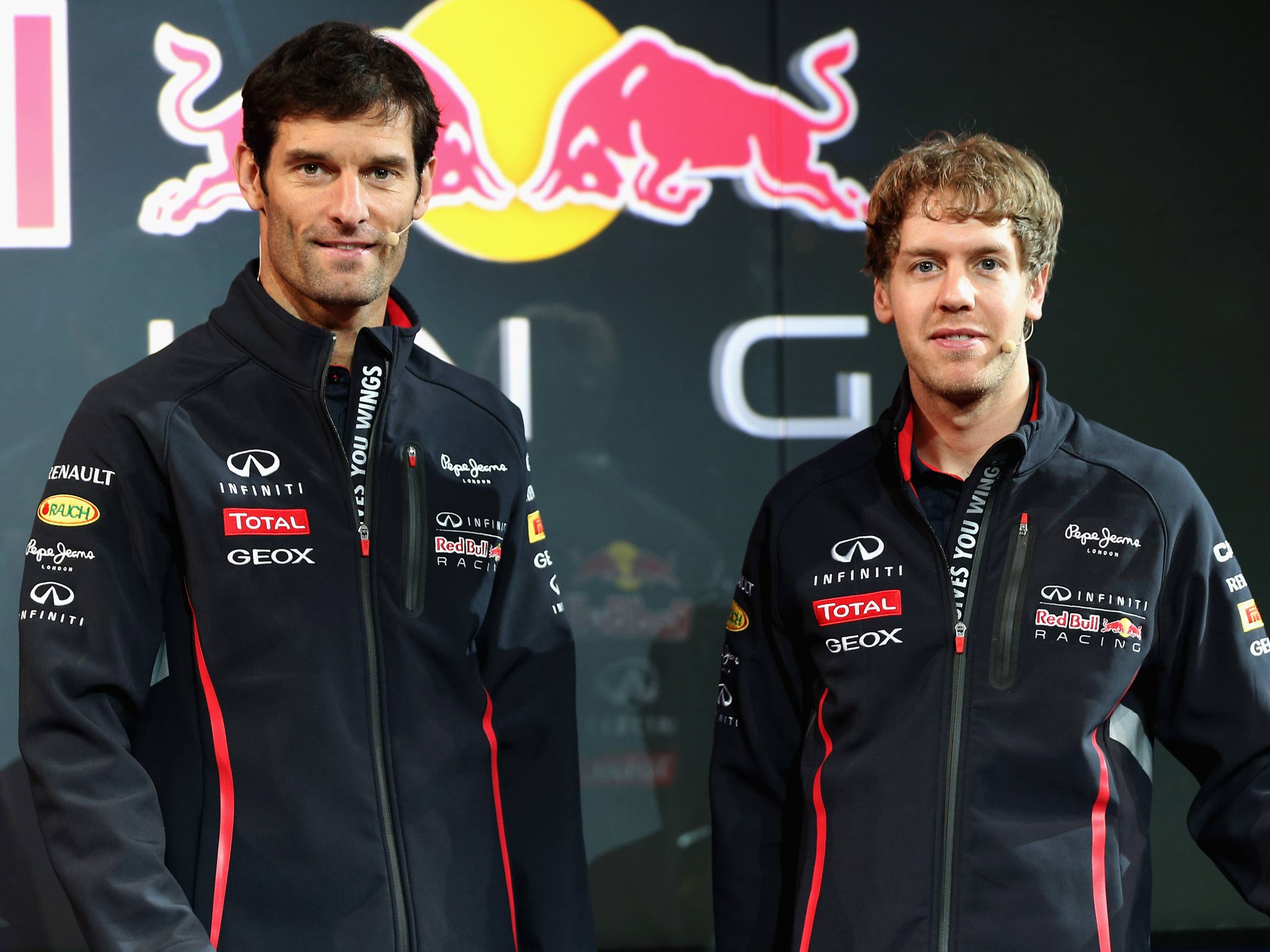 Drivers Mark Webber of Australia (and Sebastian Vettel of Germany pose during the Infiniti Red Bull Racing RB9 launch