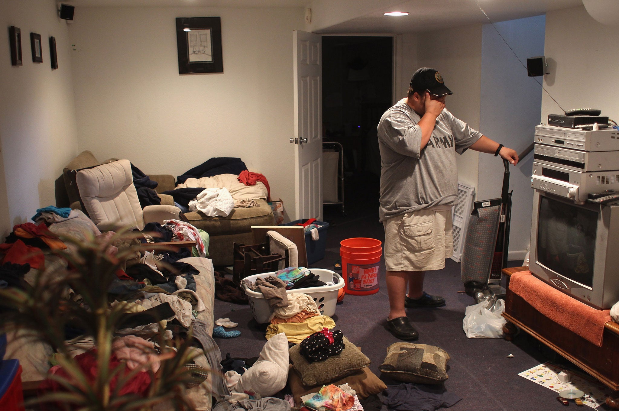 Iraq War veteran Brad Hammond pauses to rest while in the basement of his house on September 24, 2011. NB: The person depicted is not the author of this article.