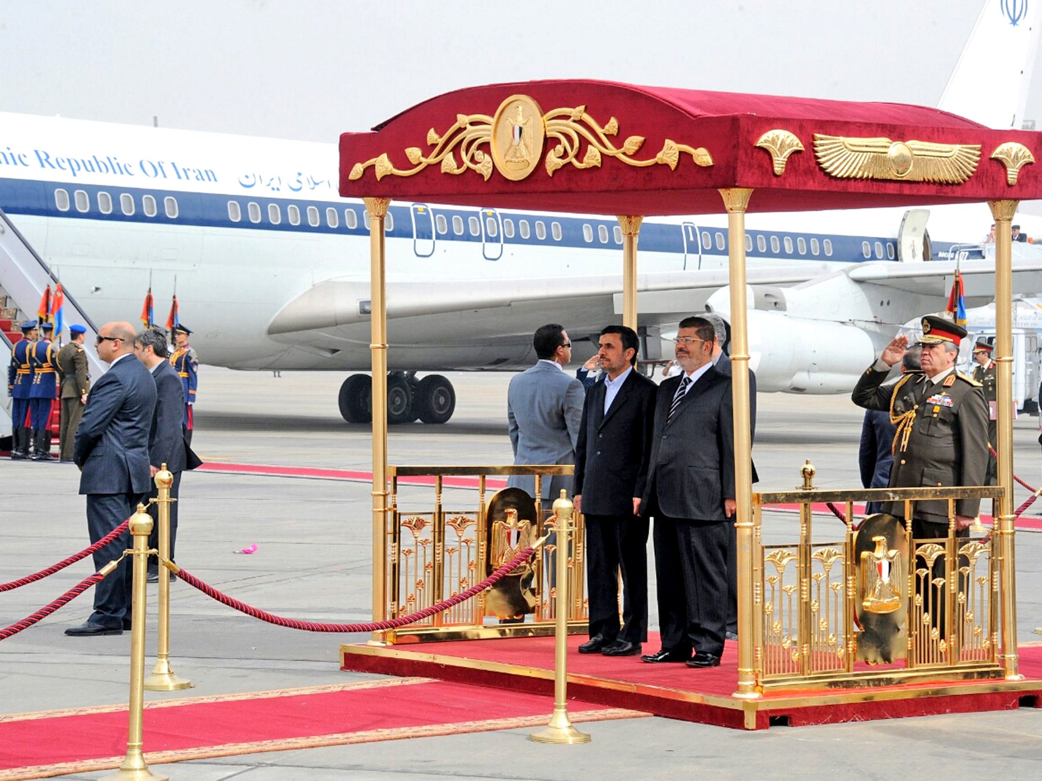 President Ahmadinejad, centre, with President Morsi