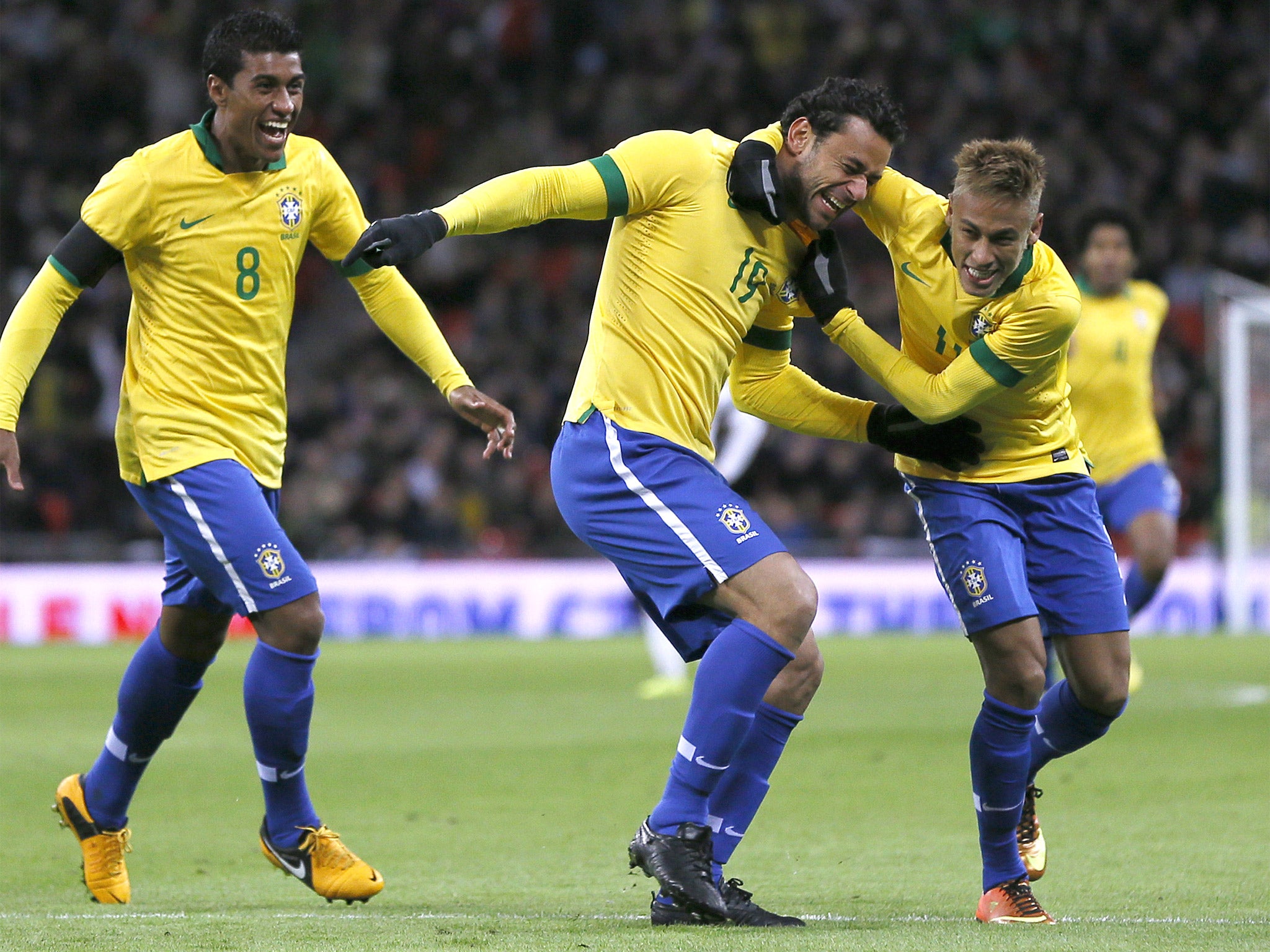 Fred (centre) celebrates his goal with Neymar (right) and Paulinho