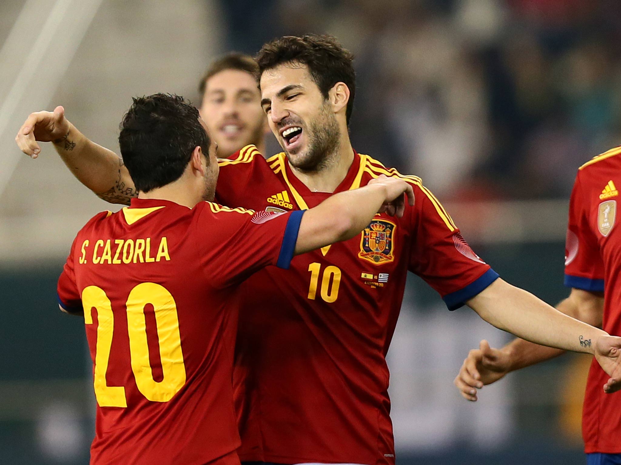 Cesc Fabrega is congratulated by Santi Cazorla as Spain beat Uruguay