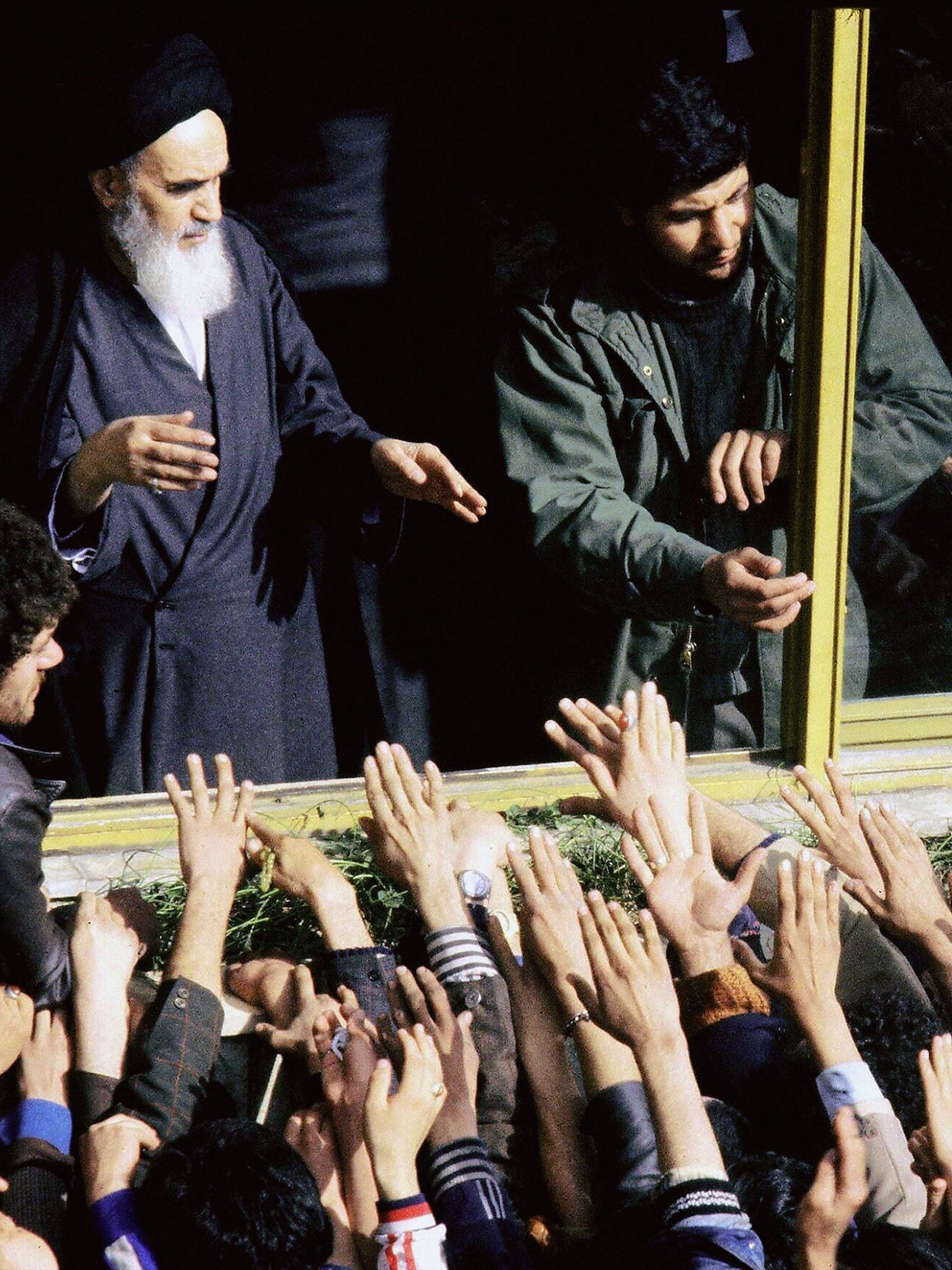 The Islamic Revolution’s founder Ayatollah Ruhollah Khomeini (L) greeted in 1979 in Tehran by his supporters during his return to Iran after 15 years in exile in Iraq and France