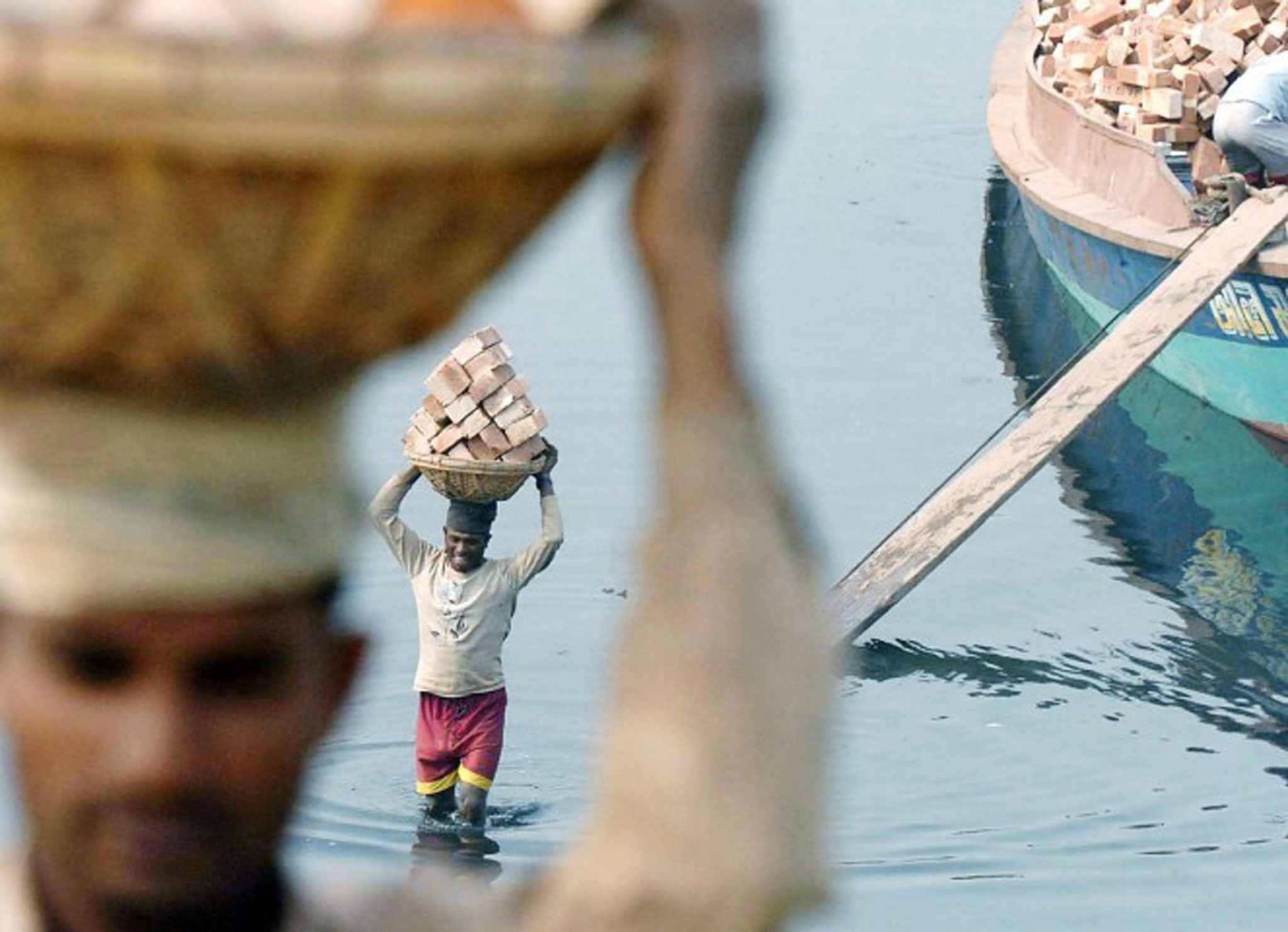 Bangladeshi labourers moving bricks: The country's economy is tipped for strong growth