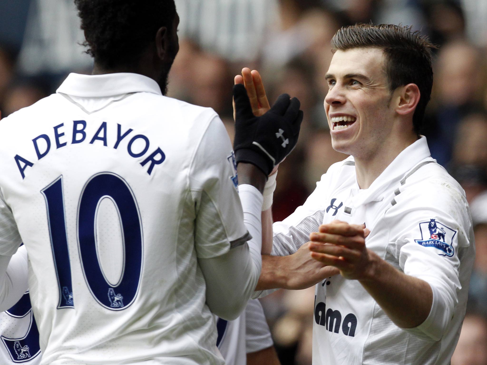 Emmanuel Adebayor celebrates with Gareth Bale