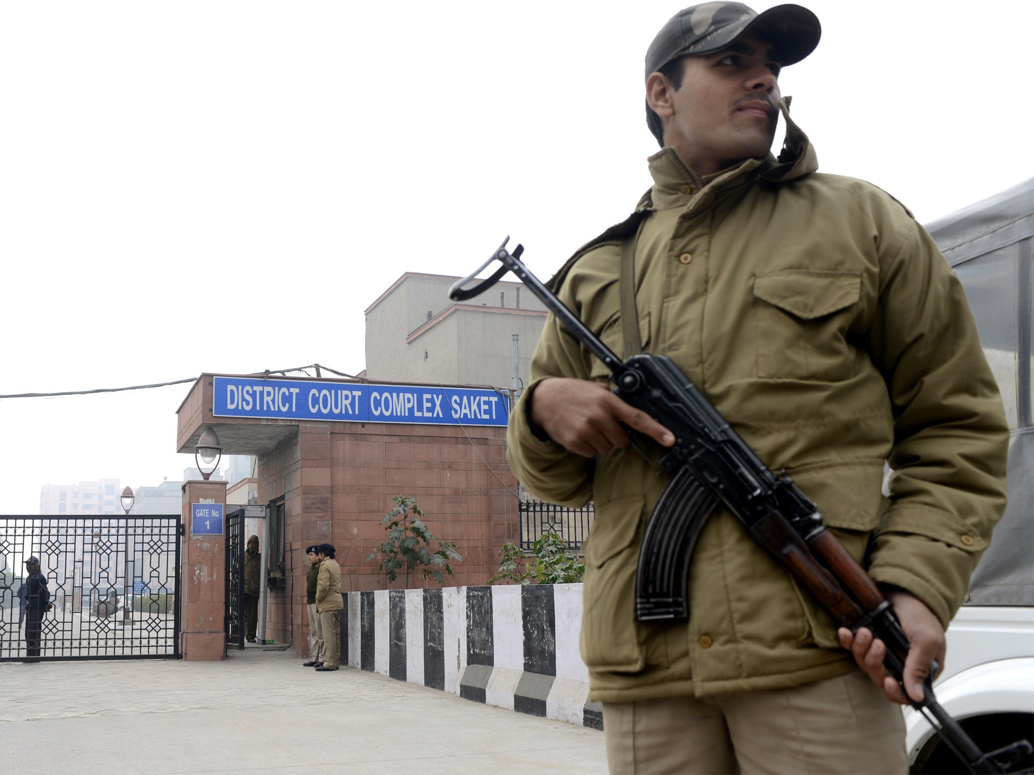 A policeman stands guard outside the Delhi court where the gang-rape accused