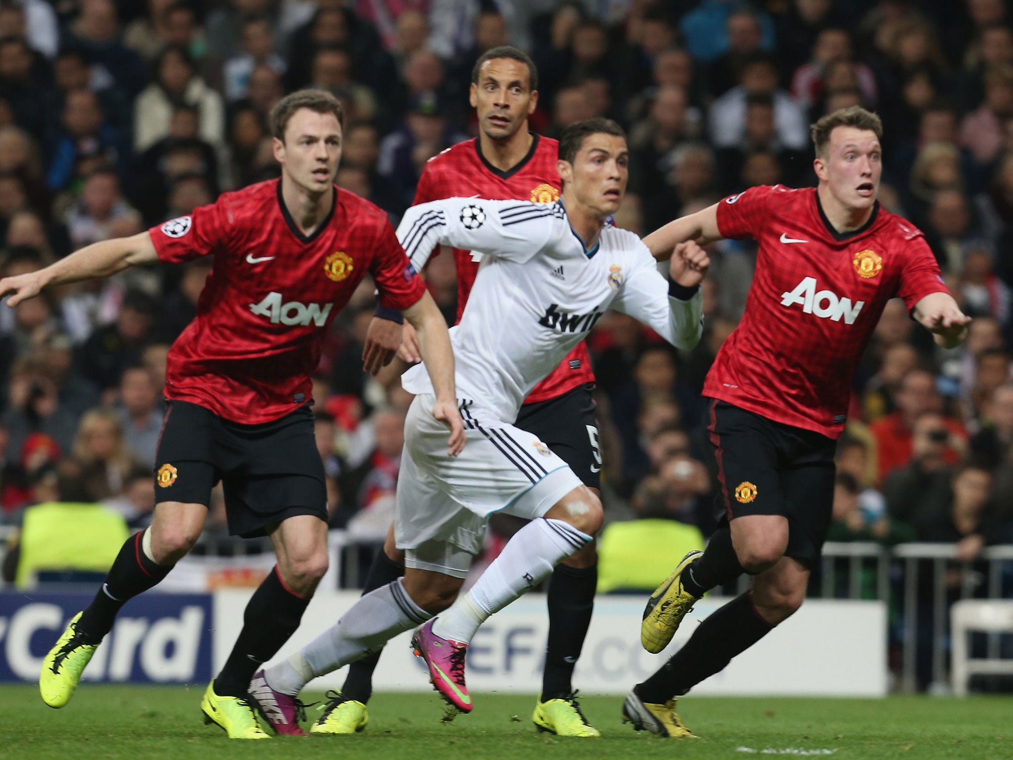 A three-man job? Jonny Evans, Rio Ferdinand and Phil Jones track Cristiano Ronaldo