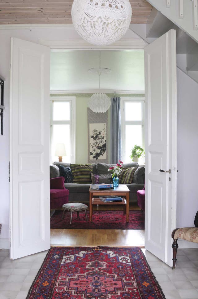 A home-made lampshade hangs over rugs Lindfors inherited from her parents