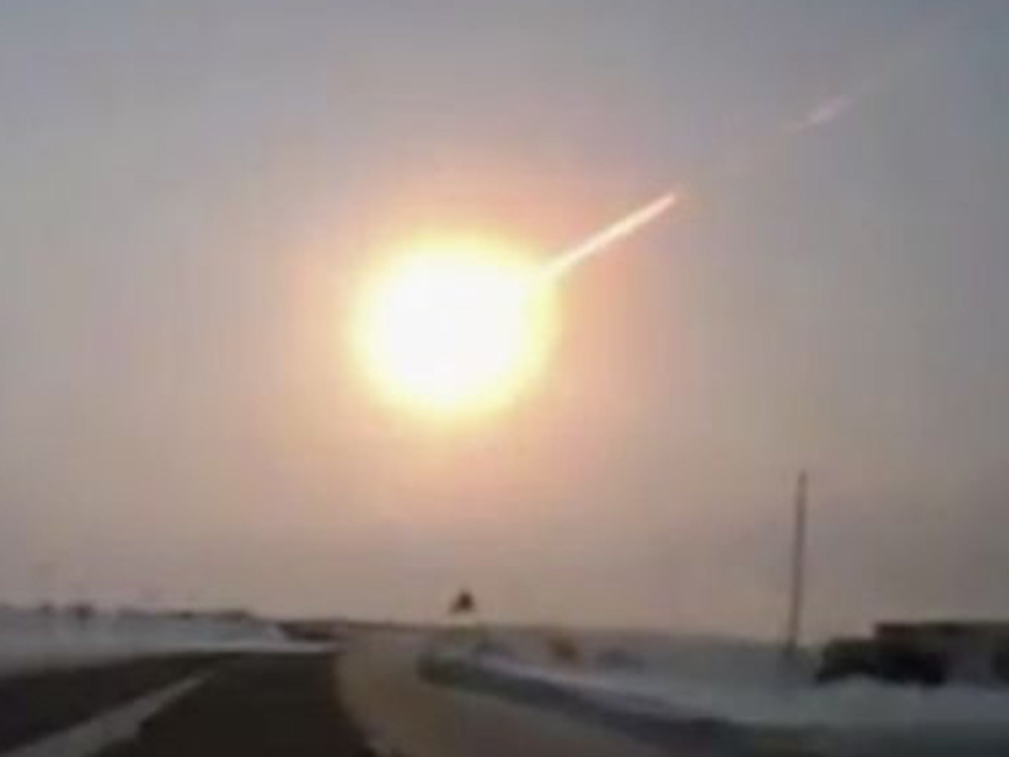 A meteor trail is seen in this frame grab made from a dashboard camera on a highway in Kazakhstan