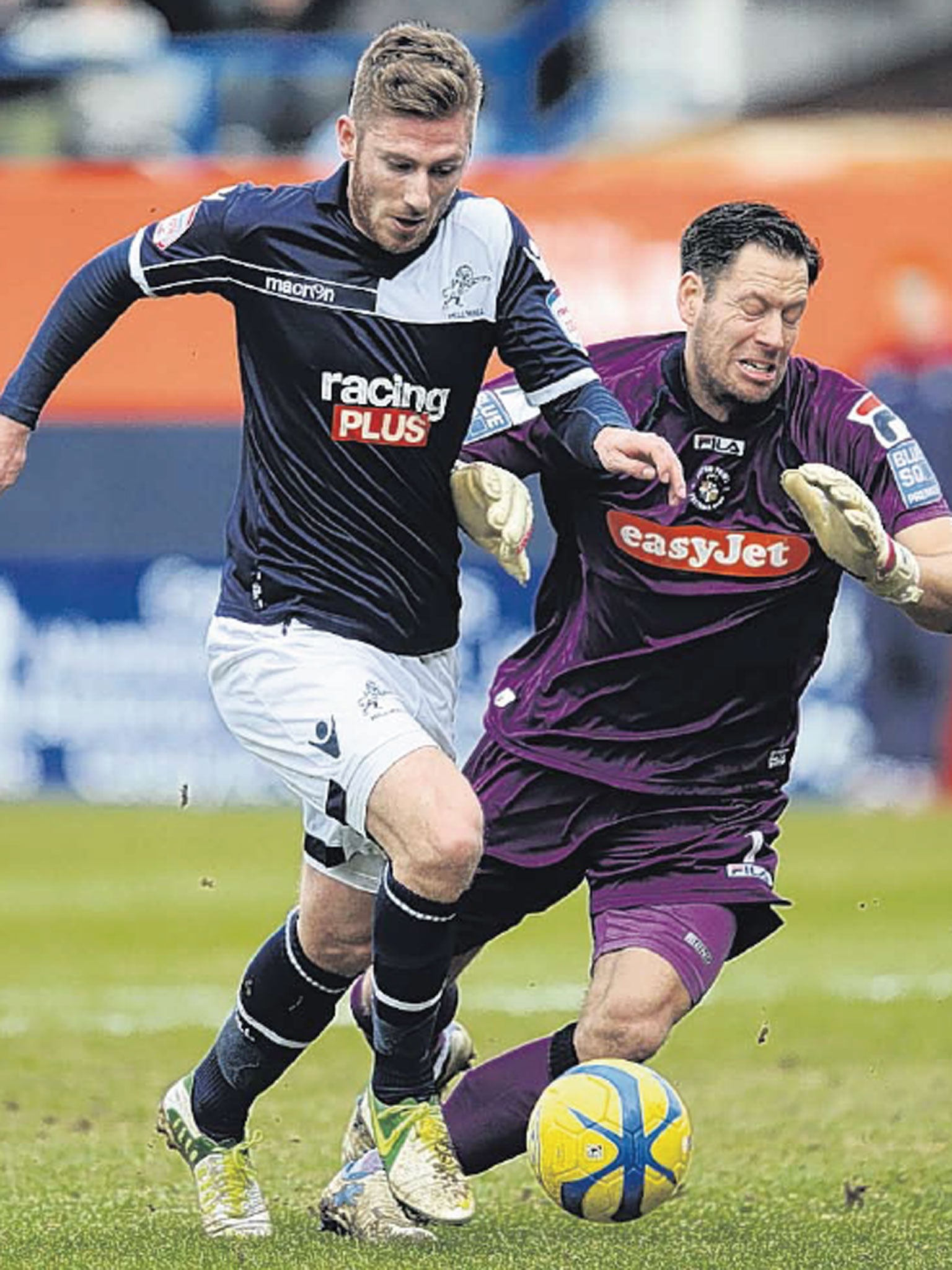 Millwall’s James Henry rounds Luton Town goalkeeper Mark Tyler
to put his side into the lead at Kenilworth Road