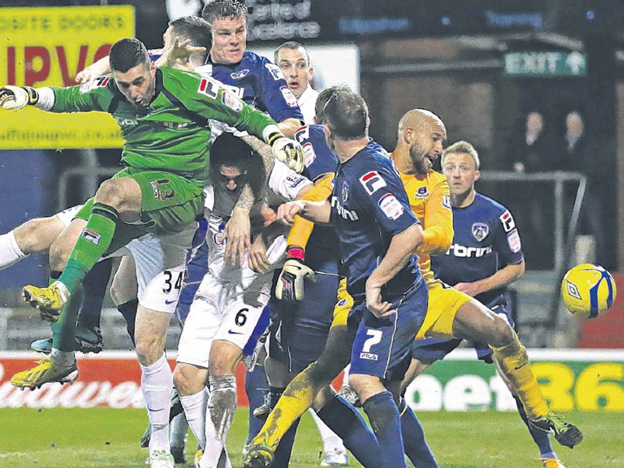 Matt Smith (top of picture) heads home for Oldham to make it 2-2