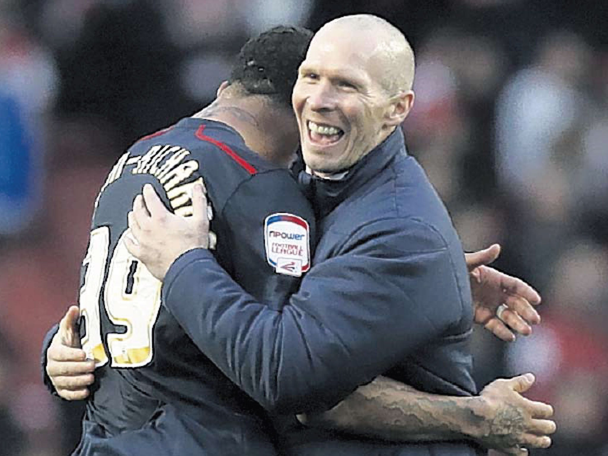 The Blackburn Rovers manager, Michael Appleton, celebrates their
shock victory with goalscorer Colin Kazim-Richards