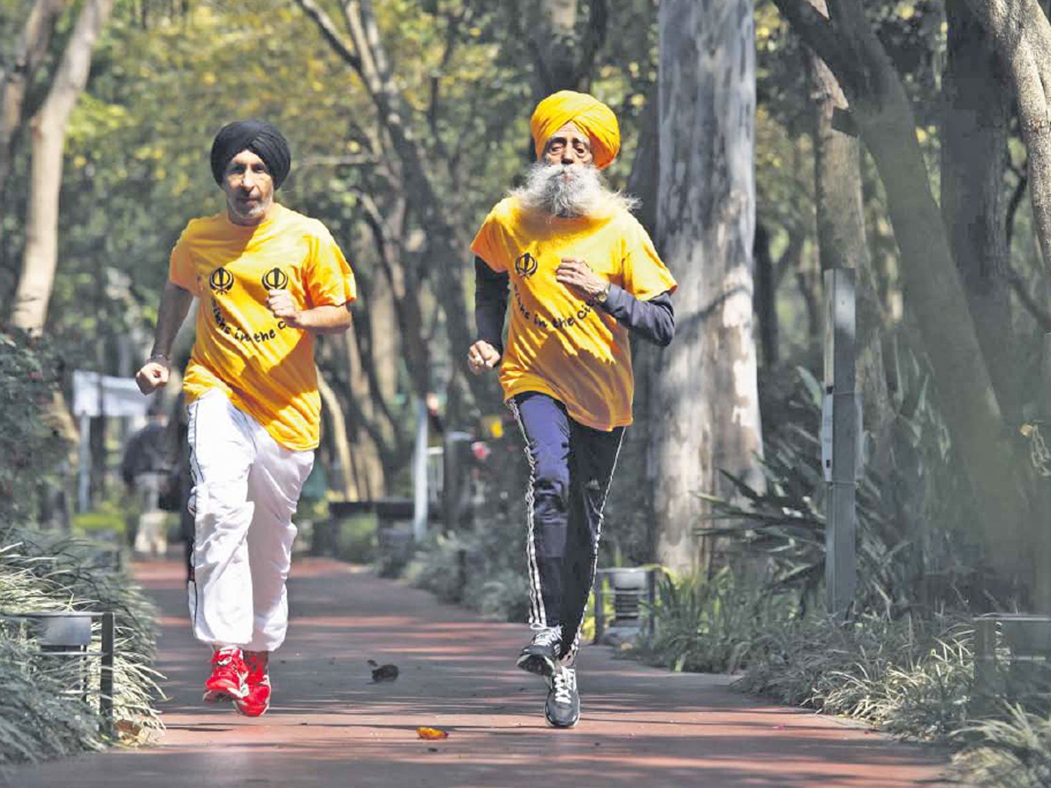 Jog the memory: Fauja Singh (right) trains in Hong Kong with coach Harmander SIngh ahead of today’s 10km race