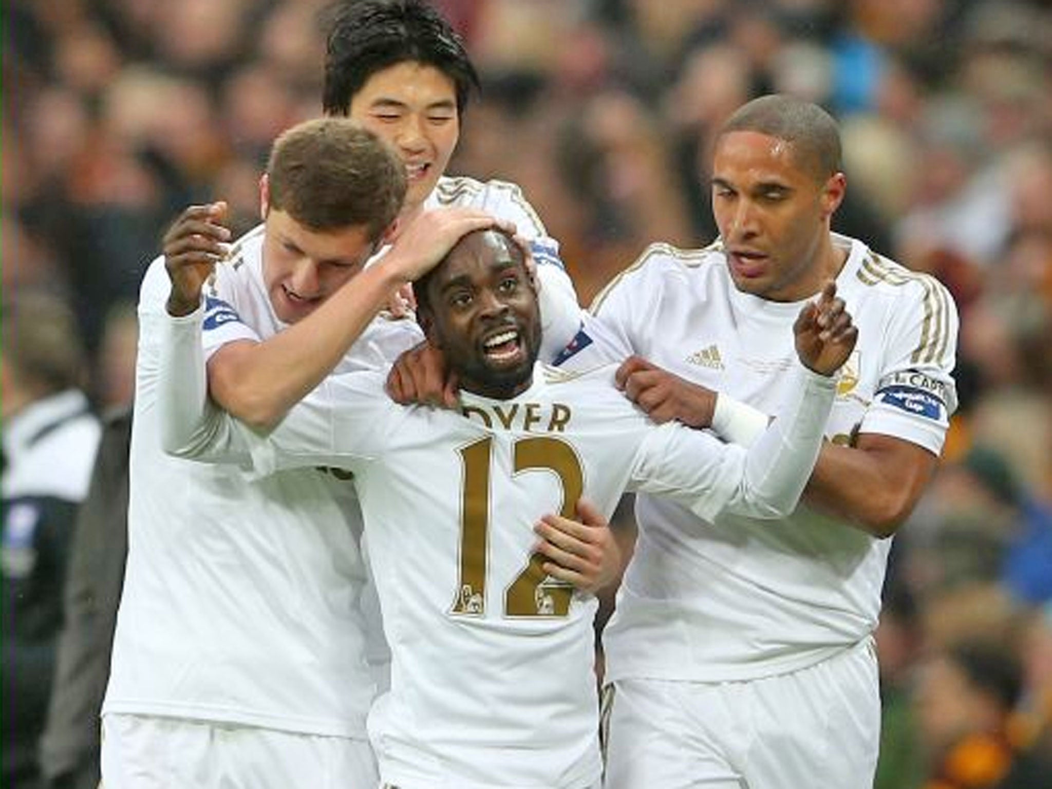 Nathan Dyer of Swansea City celebrates with team mates after scoring the opening goal against Bradford City