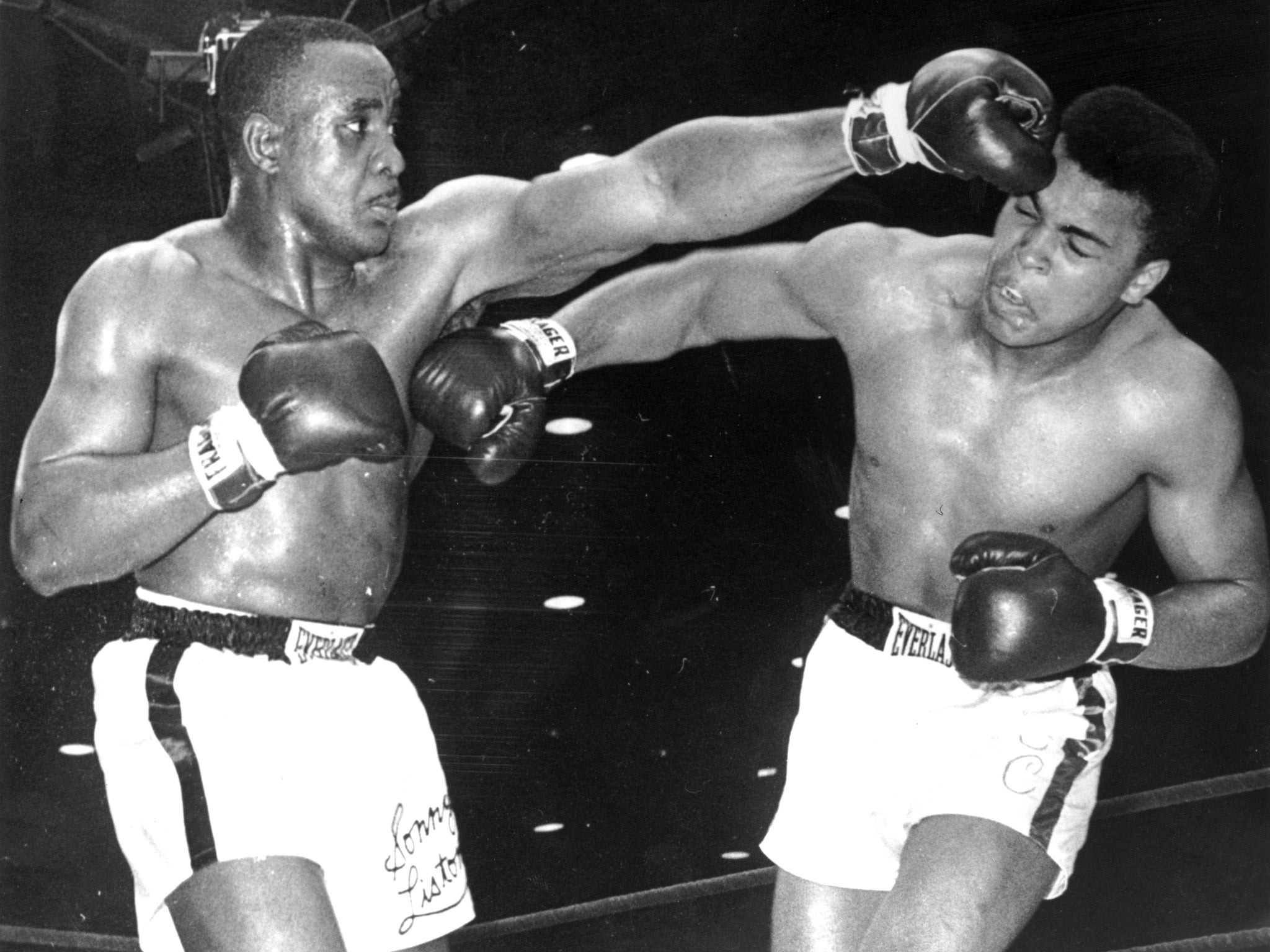 Cassius Clay (later known as Muhammad Ali) lands a right on the body of Sonny Liston in 1964