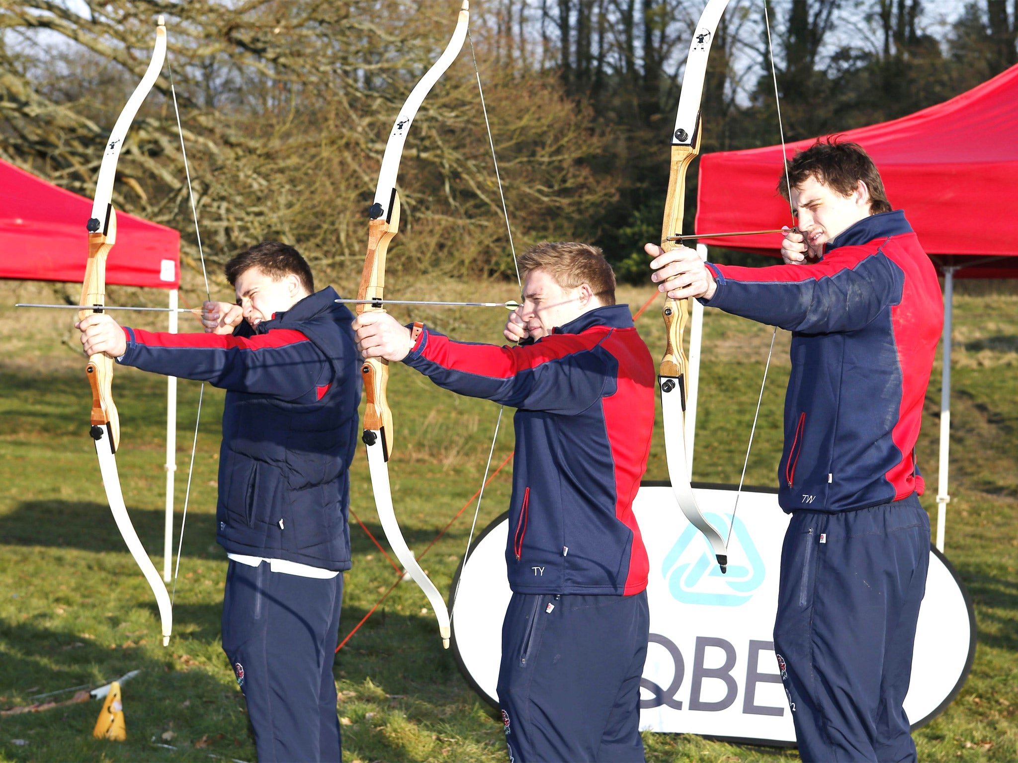 England’s Ben Youngs, Tom Youngs and Tom Wood (from left) try their hand at archery at Pennyhill Park yesterday