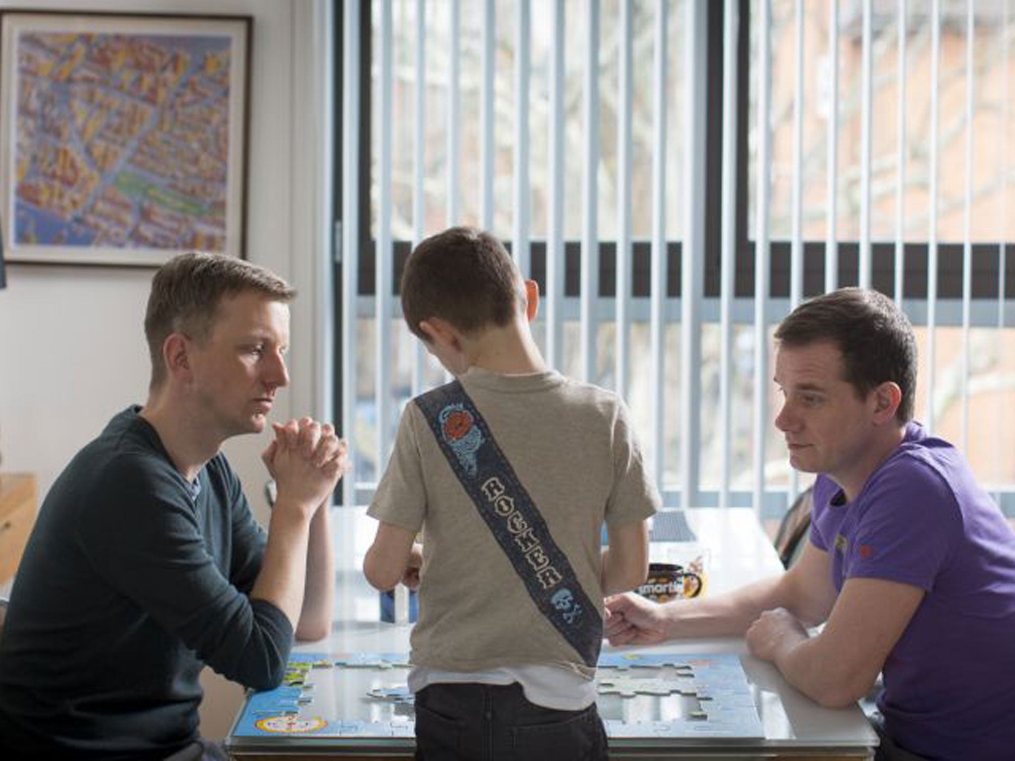 Phil Reay-Smith, left, his husband Michael McIsaac and six-year-old Scott, their adopted son