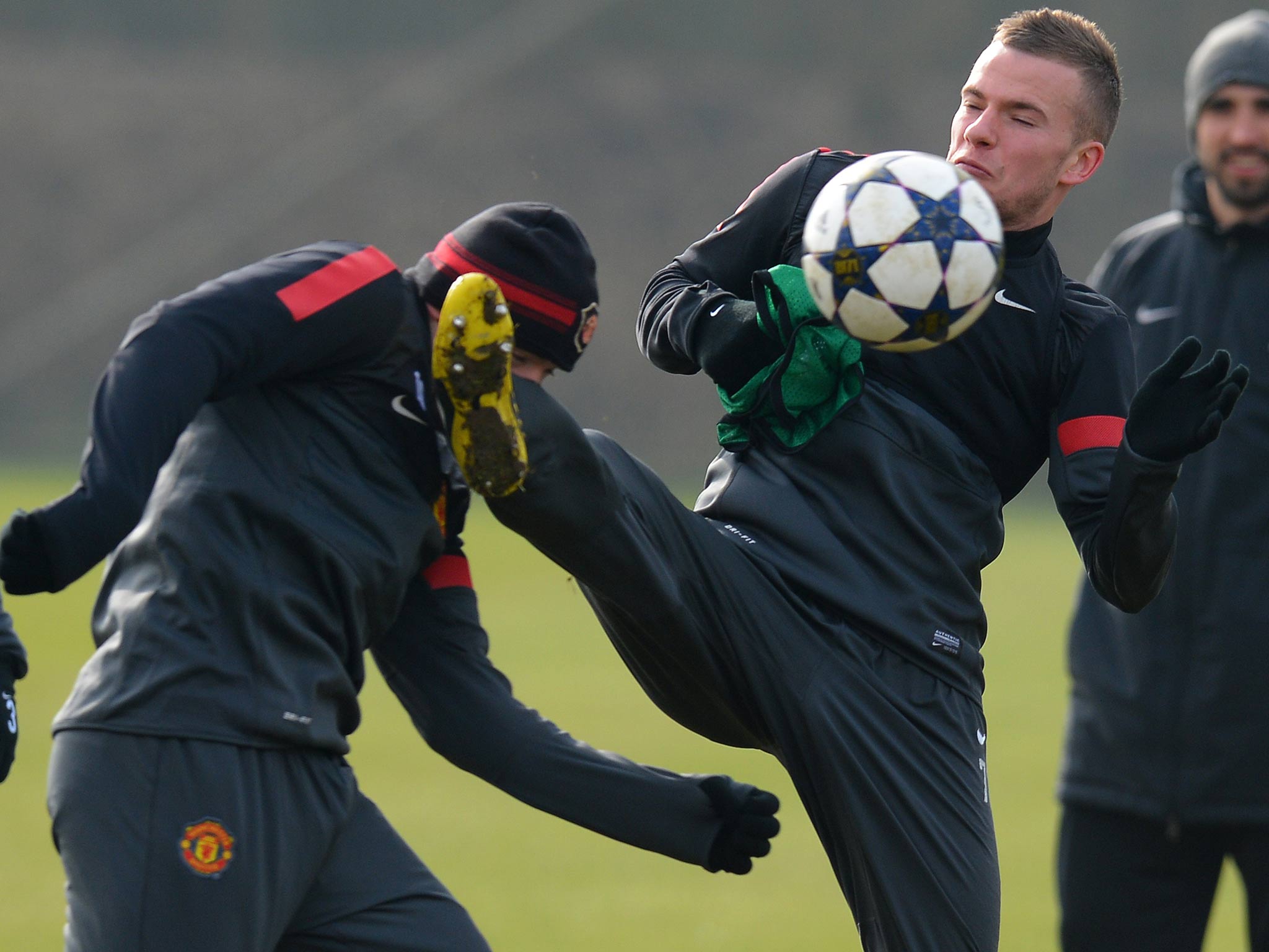 Wayne Rooney and Tom Cleverley clash during training
