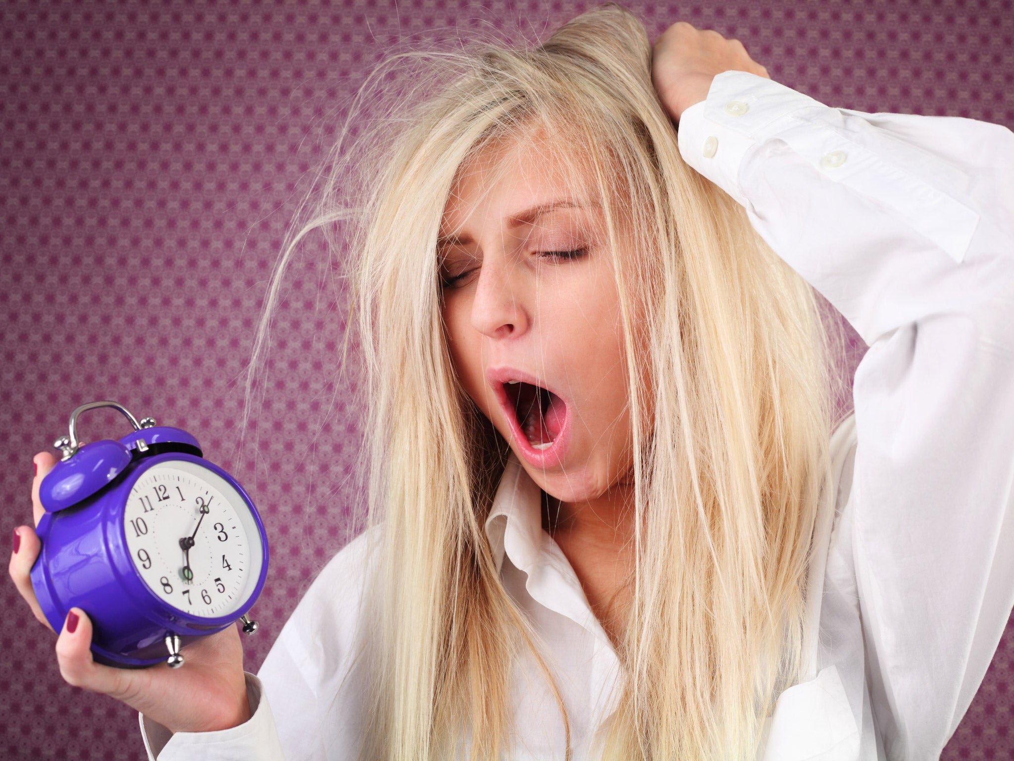 A woman yawns, posed by model