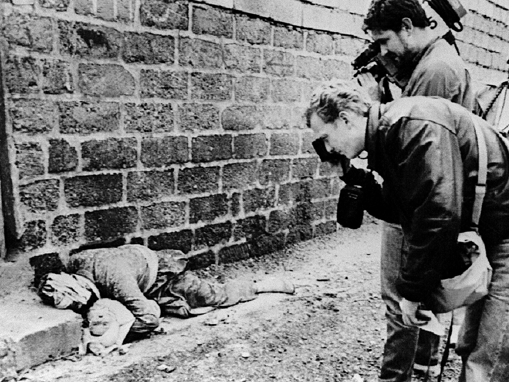 A Kurdish father holding his baby, both killed in Saddam’s chemical attack on Halabja (Getty)