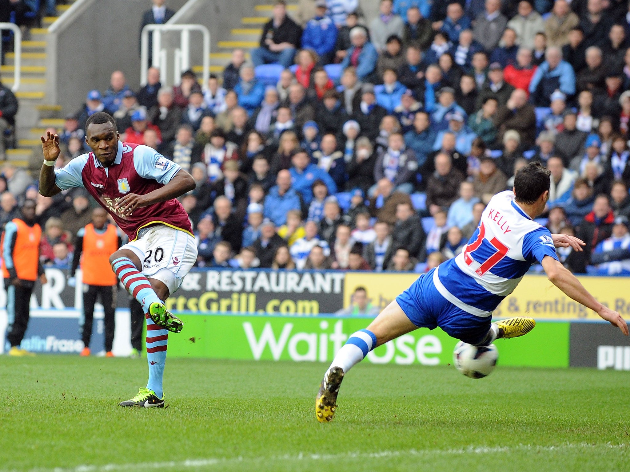 Christian Benteke of Aston Villa shoots past Stephen Kelly of Reading to score their first goal